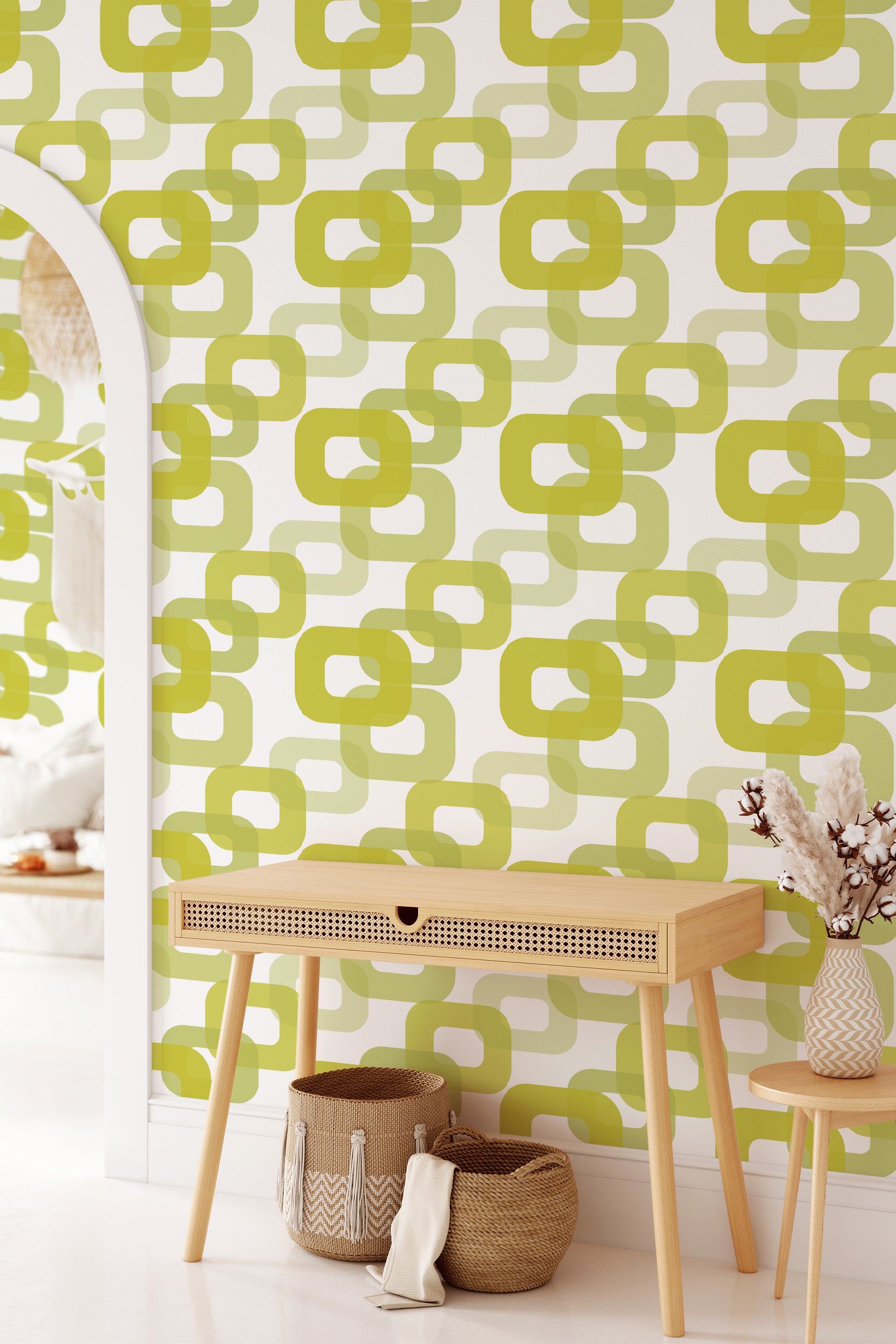 A room with 60s retro print wallpaper in shades of green and beige featuring an interlocking geometric pattern of rounded squares and ovals evoking a vintage aesthetic, traditional wallpaper.