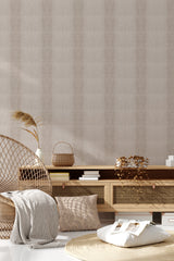 A room with beige-colored wallpaper resembling crocodile skin. The textured pattern creates a subtle and sophisticated look, adding depth to the wall. Natural elements like a wicker chair, plants, and woven baskets complement the overall aesthetic of the traditional wallpaper.