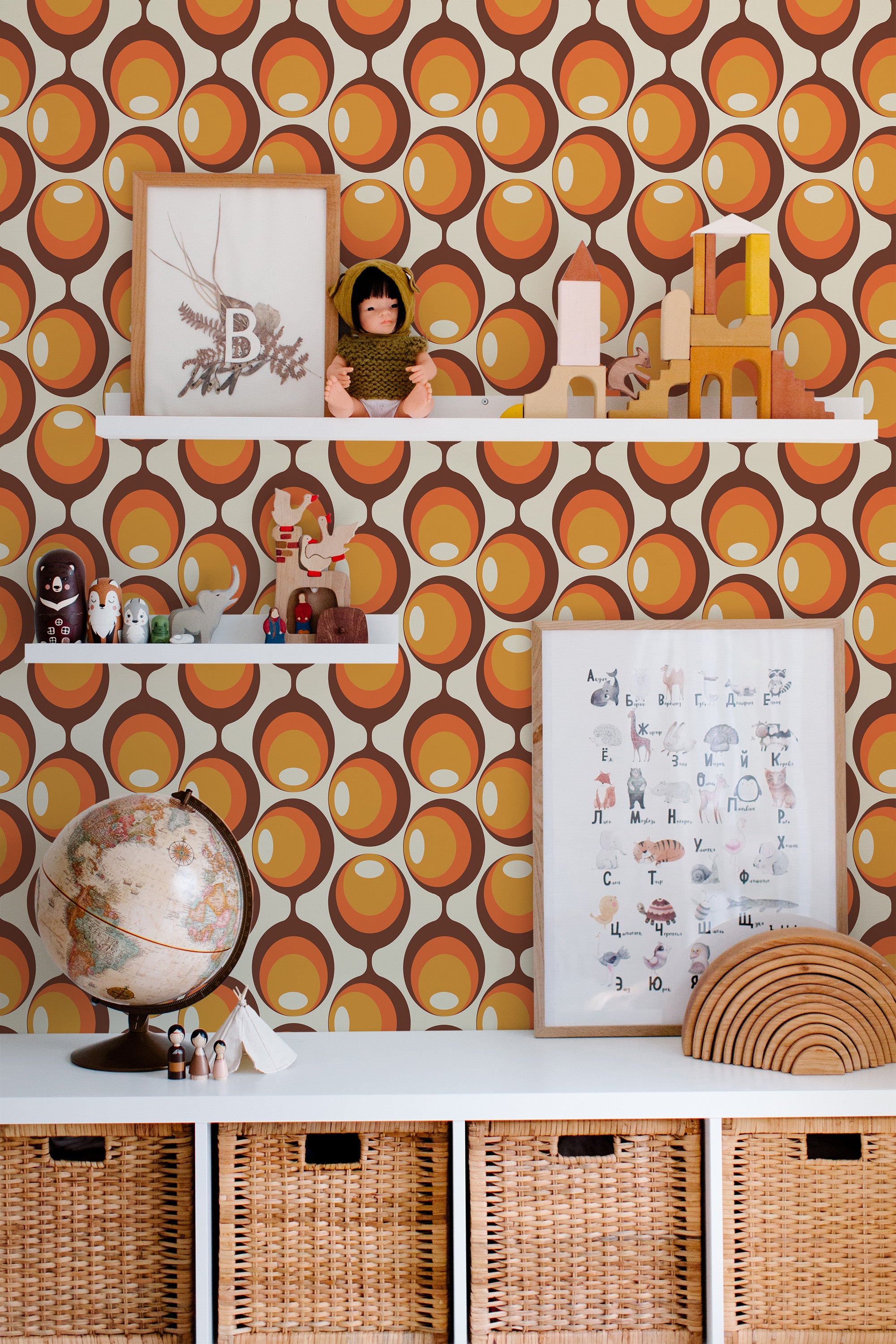 Self-adhesive wallpaper with orange, brown, and beige retro circle pattern in a room with decorative shelves and toys.