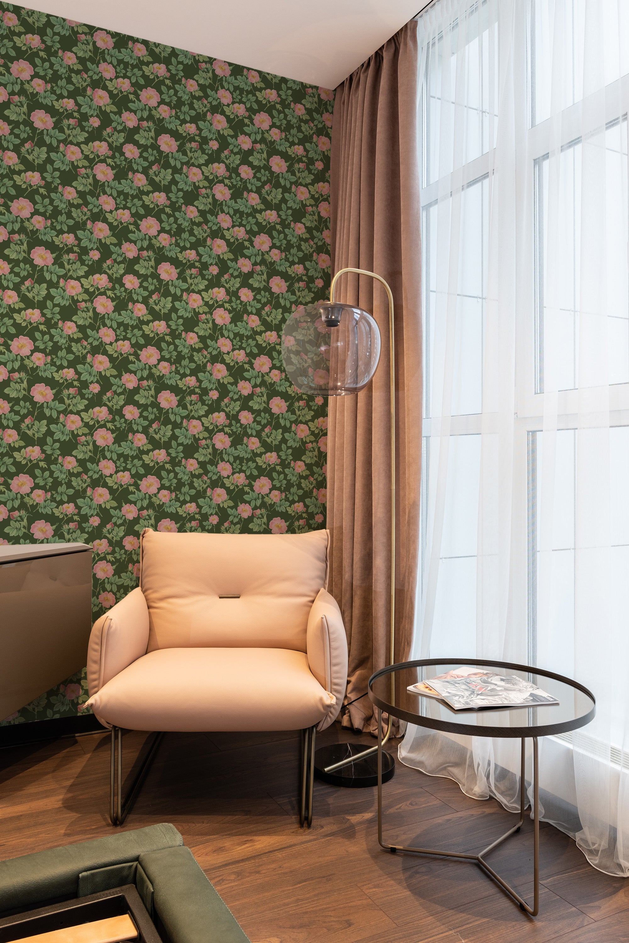 A room with Bold Rose wallpaper with large pink roses and green leaves on a dark background, complementing the earth-toned furnishings, traditional wallpaper.