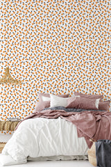 simple cozy bedroom pillows blankets orange fruit wall decor