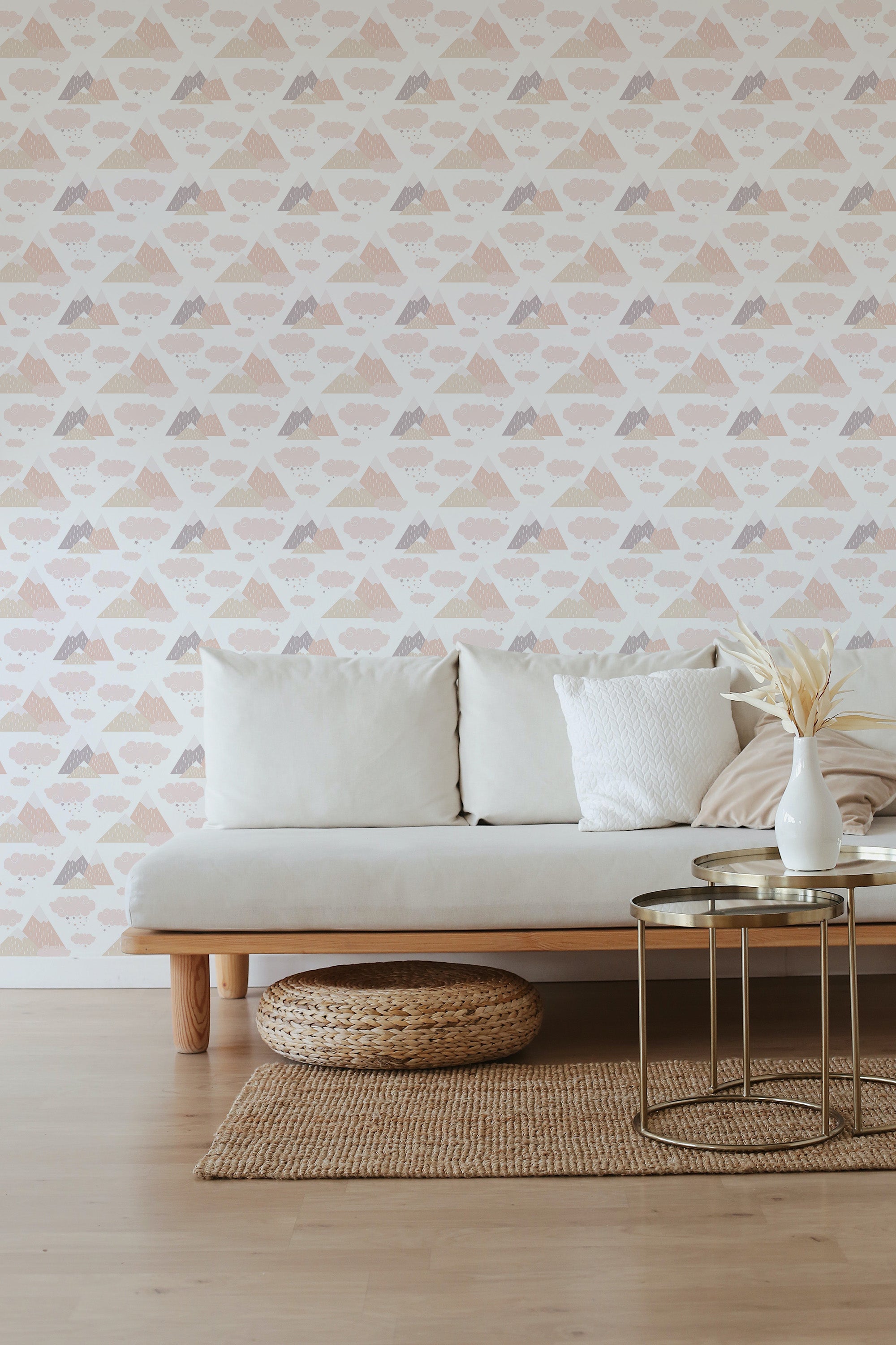 A minimalist living room with a wall adorned by geometric mountain-patterned wallpaper in pastel hues, complemented by a simple beige sofa and neutral decor, embodying a serene traditional wallpaper aesthetic.