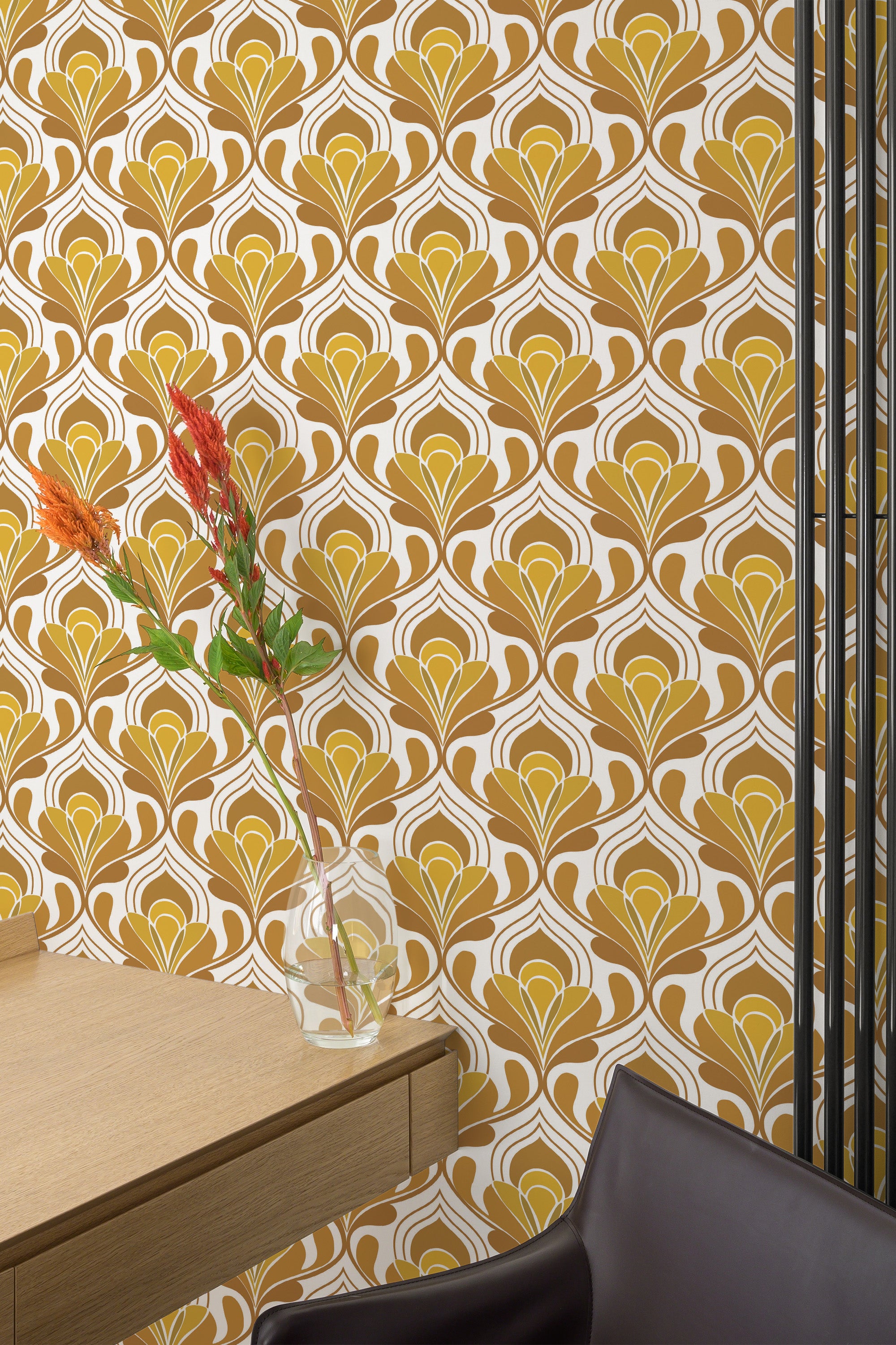 Self-adhesive yellow retro wallpaper with geometric patterns and a vase with orange flowers on a wooden table against the wall.