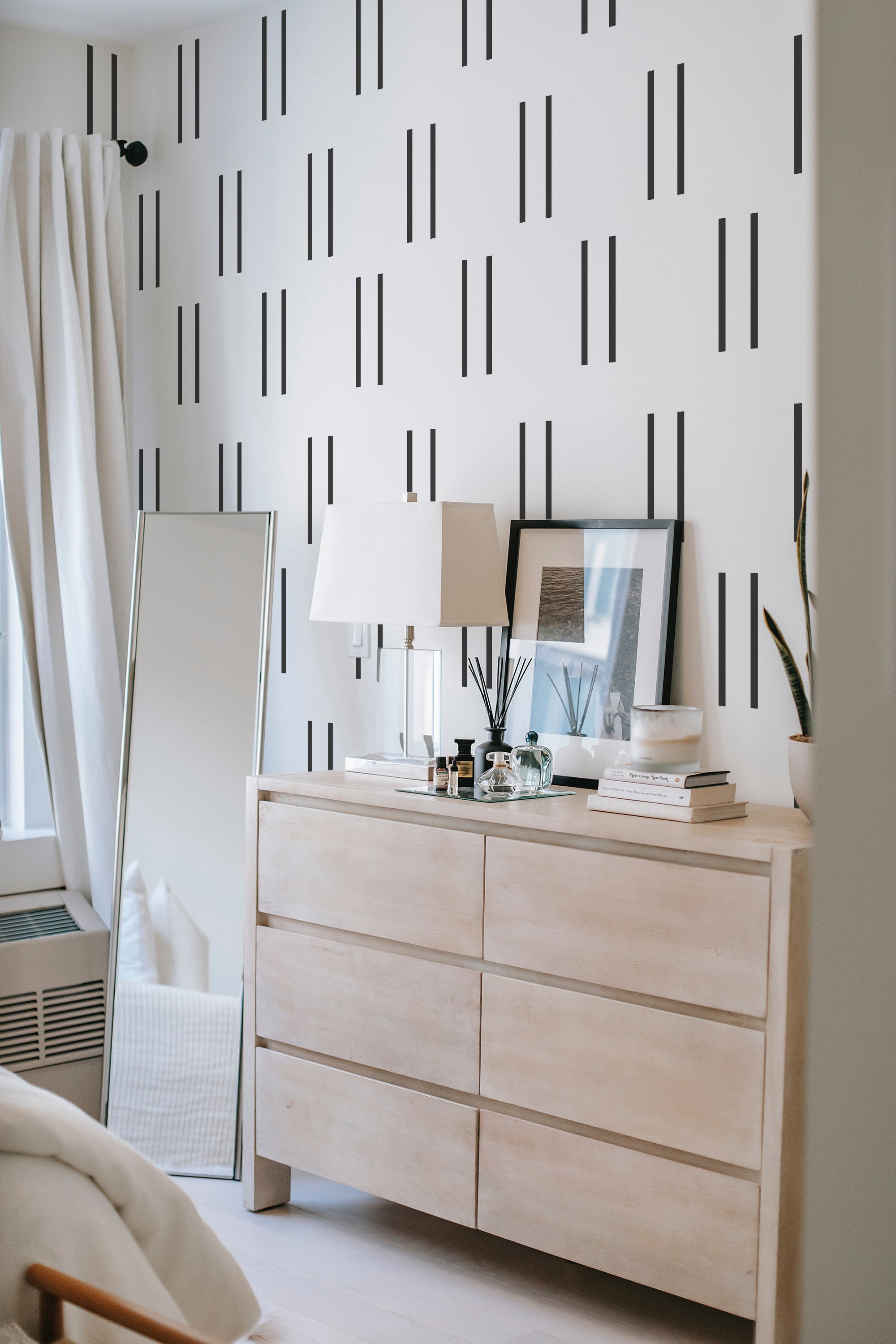 A room with Simple Striped wallpaper, vertical black lines on a white background adding a modern yet traditional wallpaper touch.