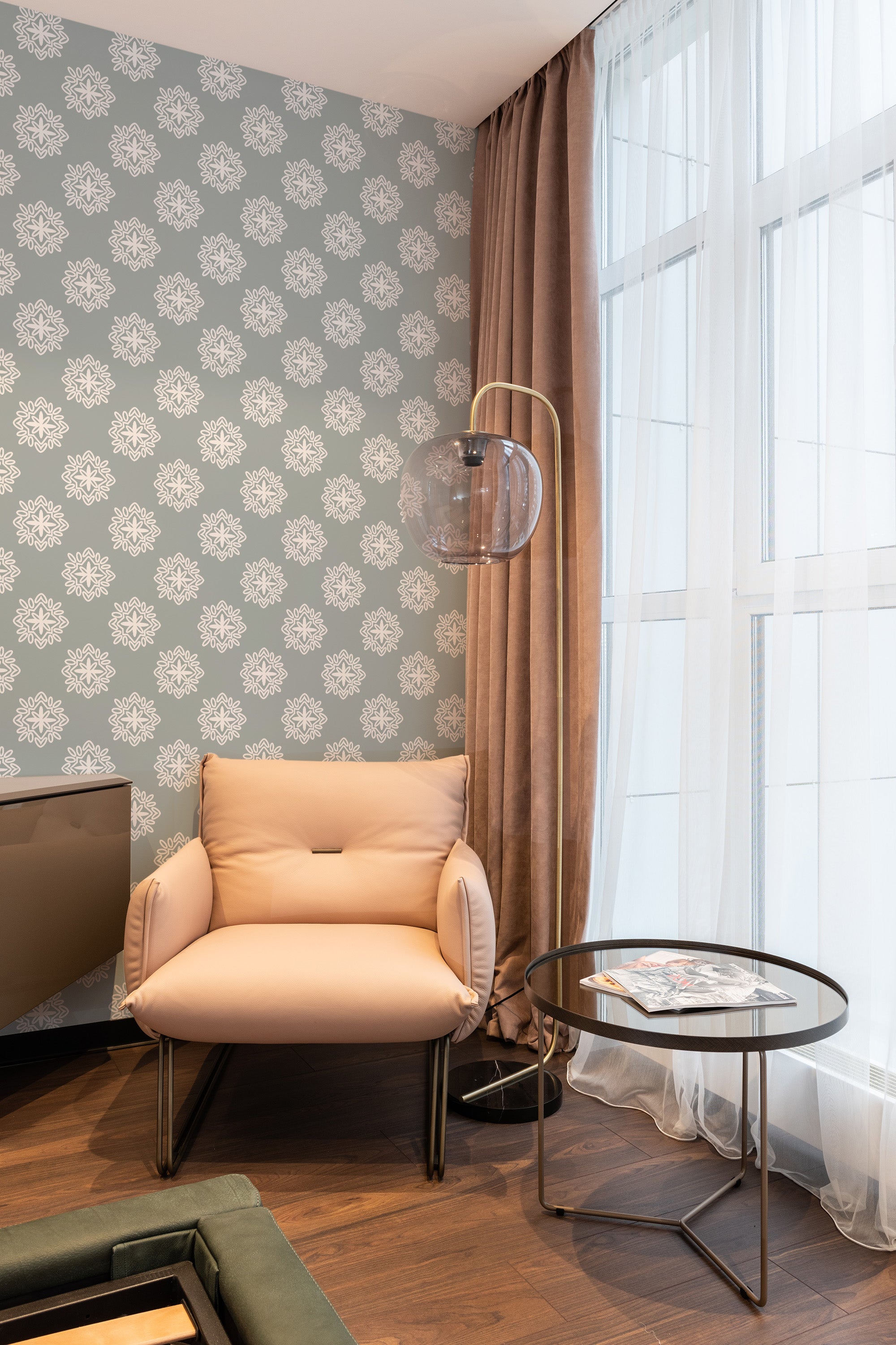 A room with beige and white retro ornamental wallpaper with a floral and geometric pattern, combined with brown curtains and modern furniture for a contrasting look, traditional wallpaper.