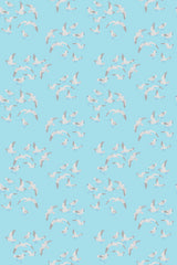 White seagulls in flight on a light blue background, seamless pattern for peel and stick removable wallpaper.