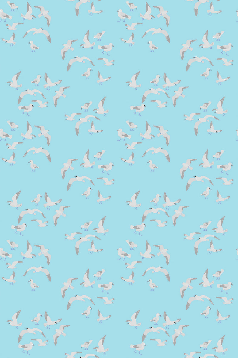 White seagulls in flight on a light blue background, seamless pattern for peel and stick removable wallpaper.