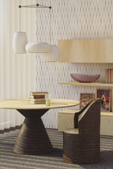 A room with a wall adorned with neutral-colored wallpaper with a pattern of evenly spaced dots, complementing the modern furniture, described as traditional wallpaper.