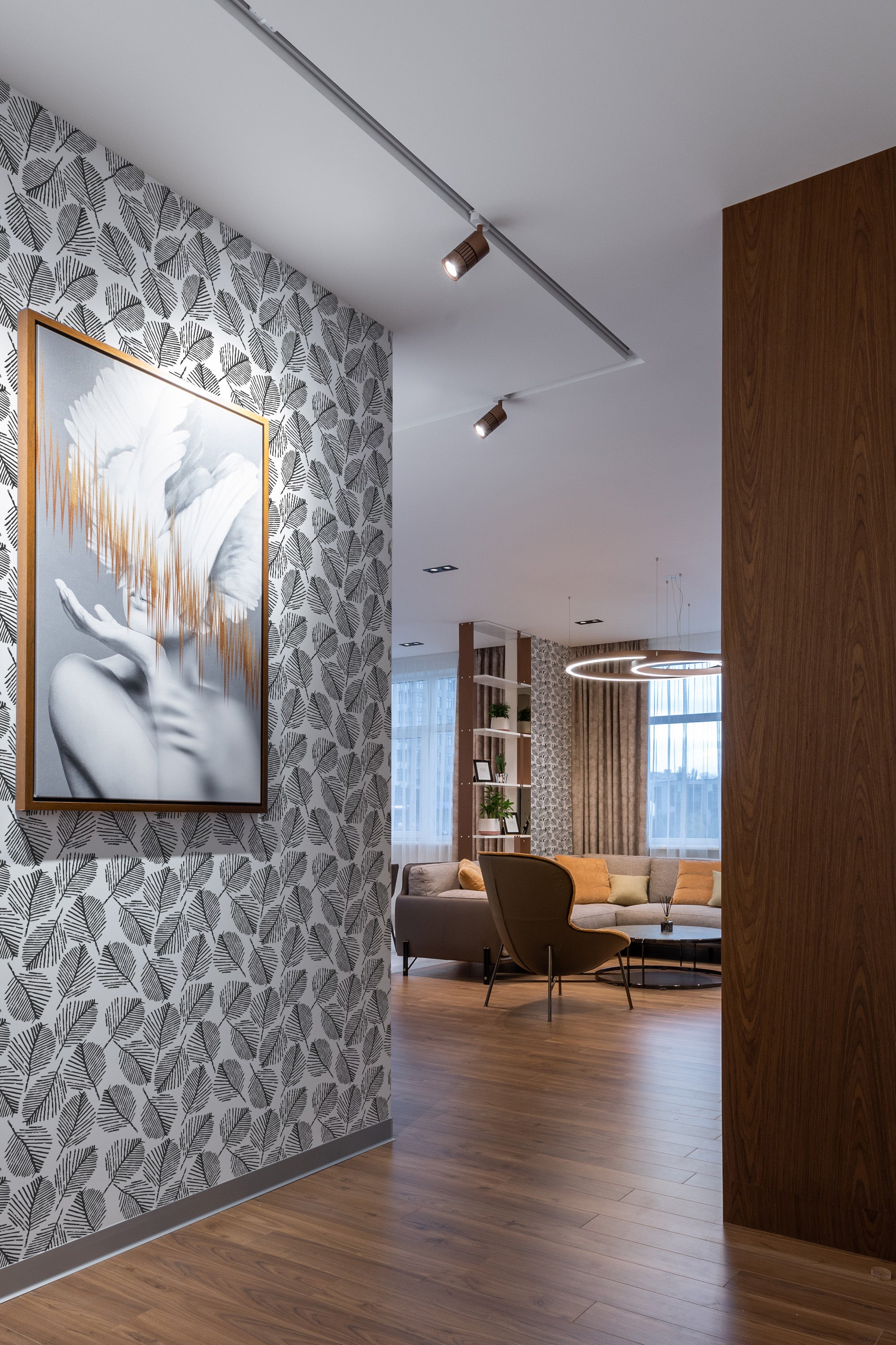 A room with leaf stencil-designed wallpaper in shades of grey, creating a naturalistic yet traditional wallpaper appearance.