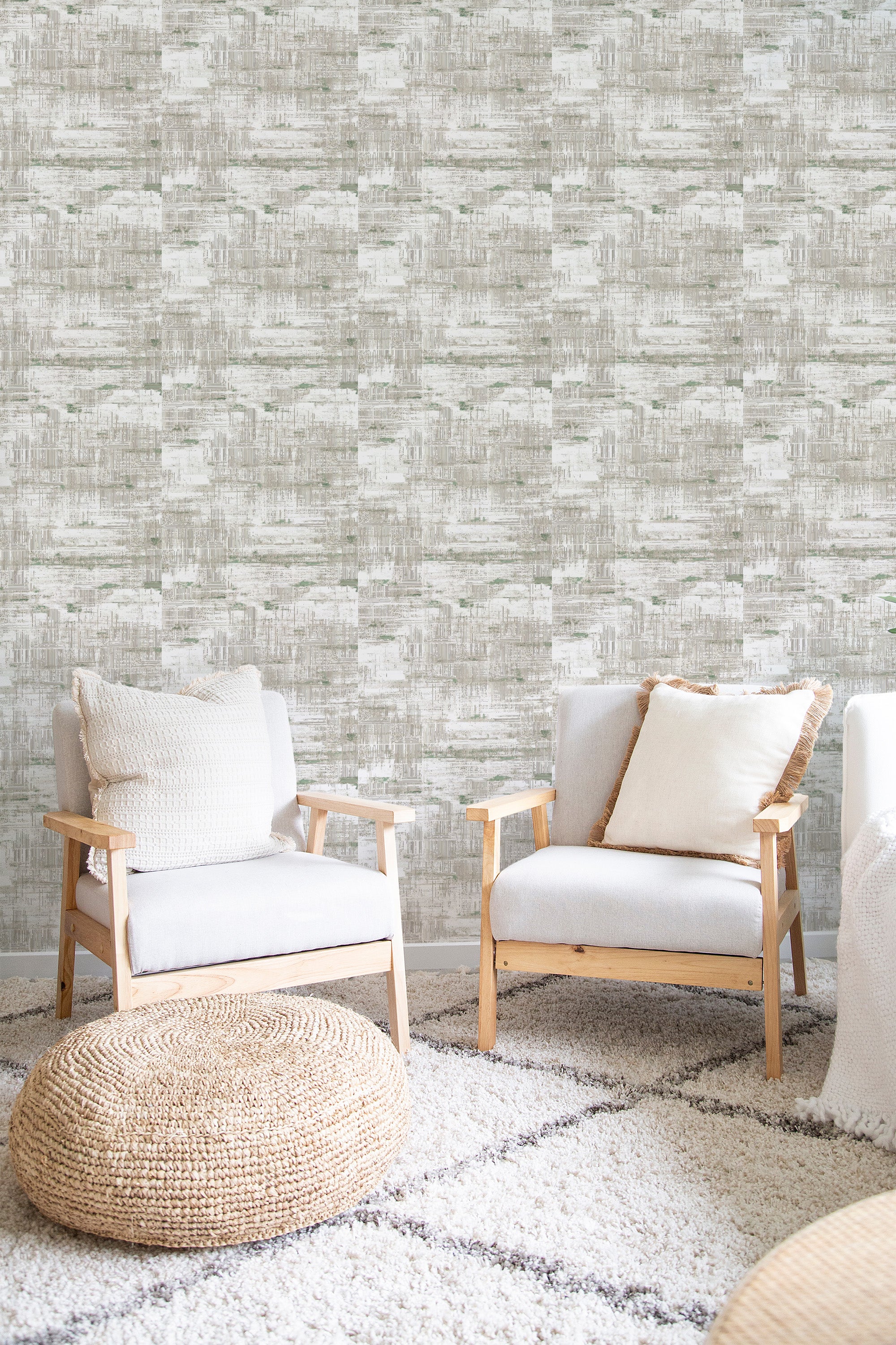 Retro textured wallpaper with a distressed, abstract pattern in neutral tones, complementing the natural wooden furniture and soft fabrics, creating a cozy, modern space with traditional wallpaper.