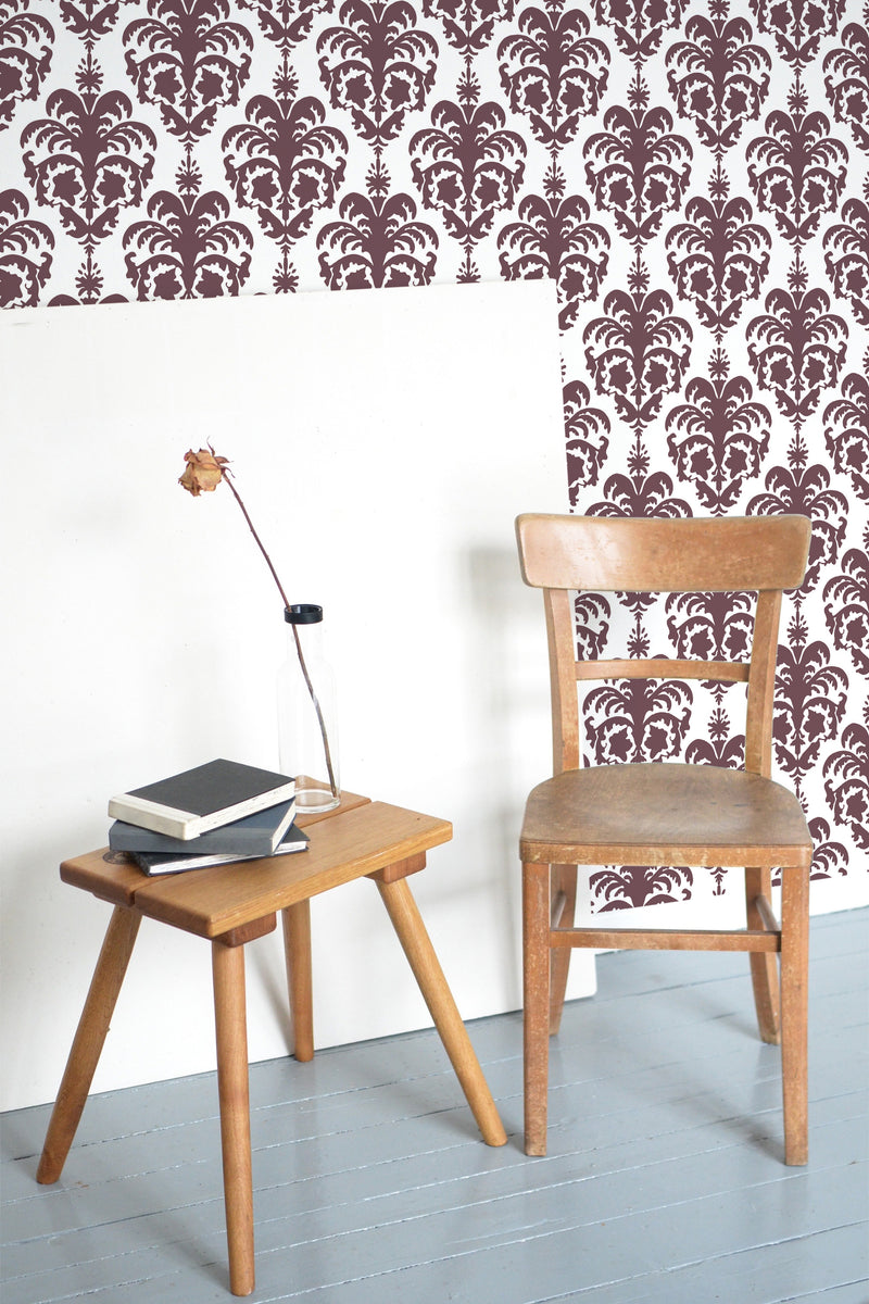 Self-adhesive Colonial wallpaper with a vintage, intricate brown damask pattern set against a white background. The symmetrical, ornate design adds a touch of traditional elegance to the room.