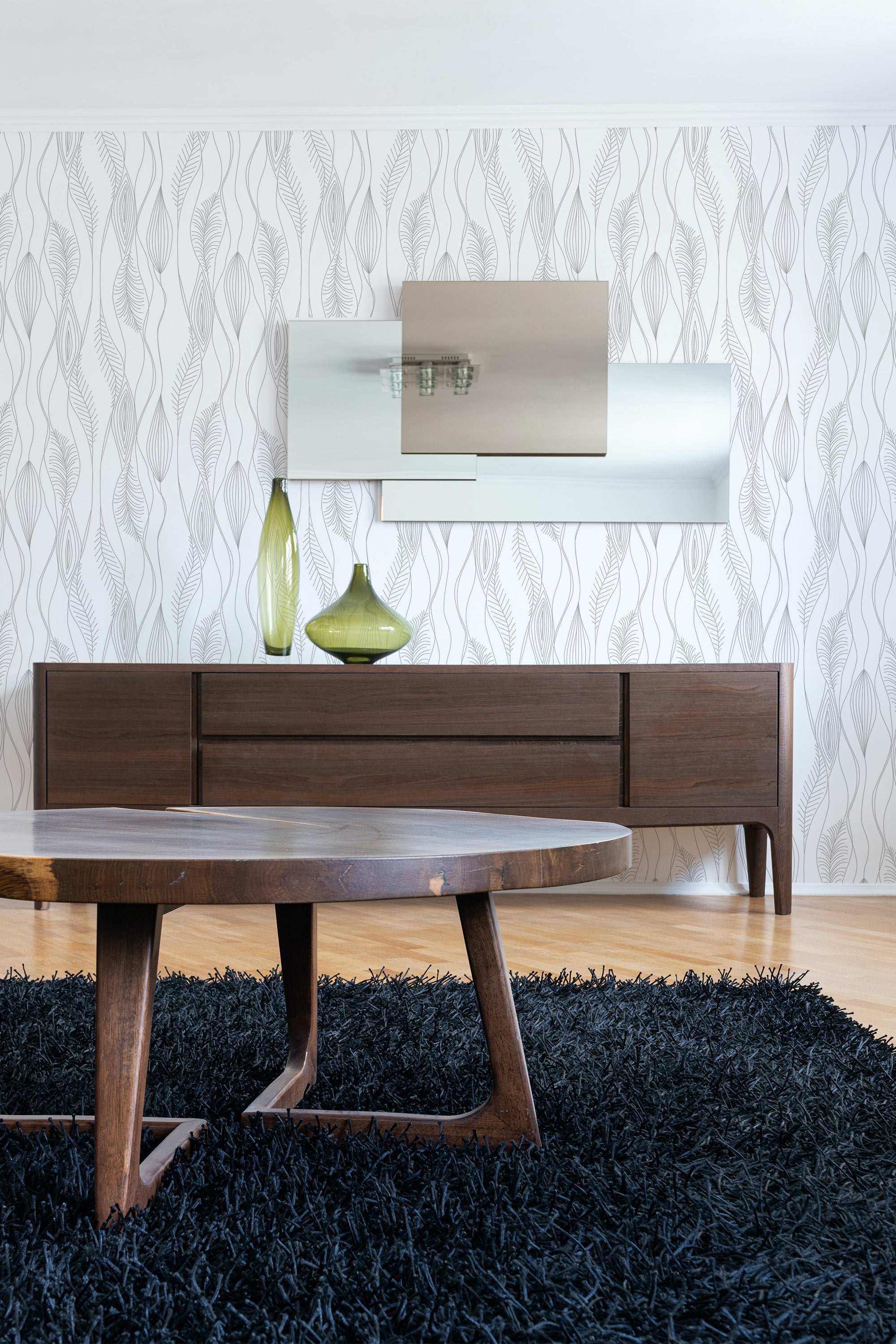 Subtle, flowing lines in a wavy pattern create an elegant, minimalist design on the wallpaper, complementing the modern aesthetic of the room. Traditional wallpaper.