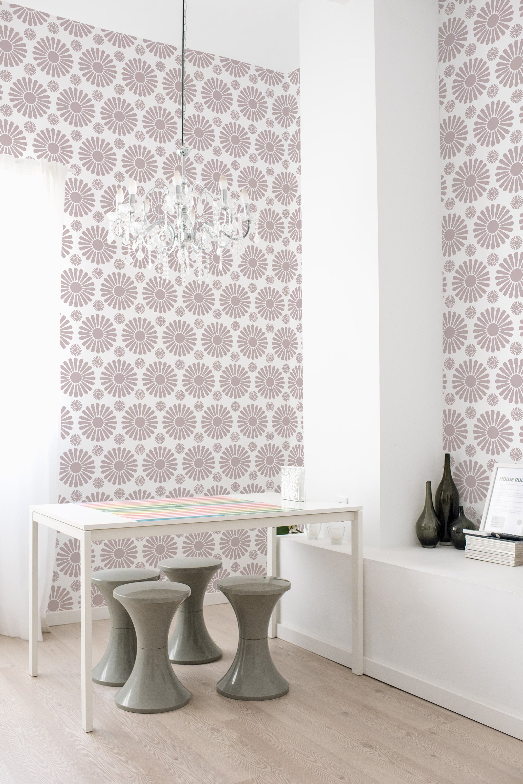 Floral wallpaper with a geometric pattern of soft pink flowers on a light background, covering the walls and providing a classic, elegant atmosphere in the room. Traditional wallpaper.