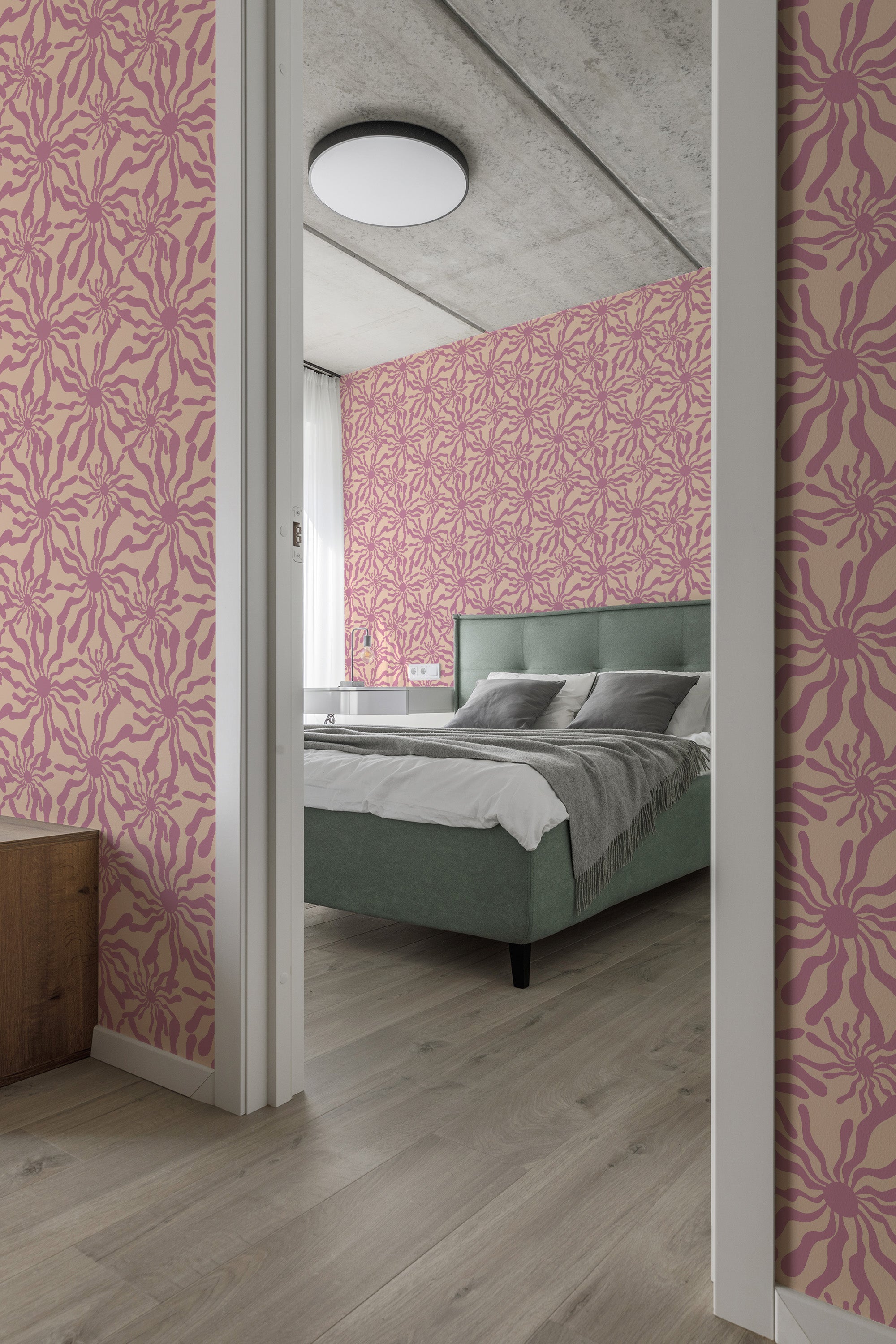 Wallpaper with a lively and symmetrical design in shades of pink, forming intricate, sun-like patterns on a pale background, adding a vibrant and whimsical touch to the room. Traditional wallpaper.