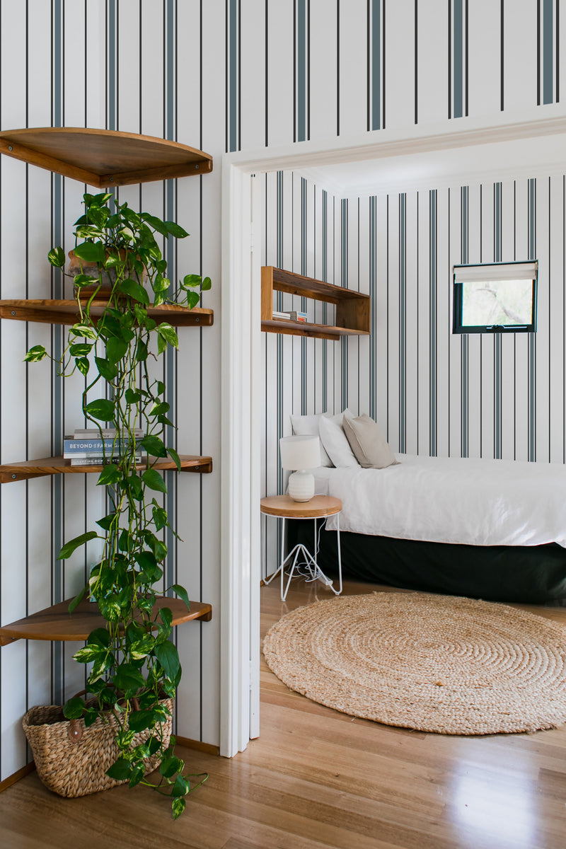 bedroom cozy interior green plants round carpet fabric stripe peel & stick wallpaper