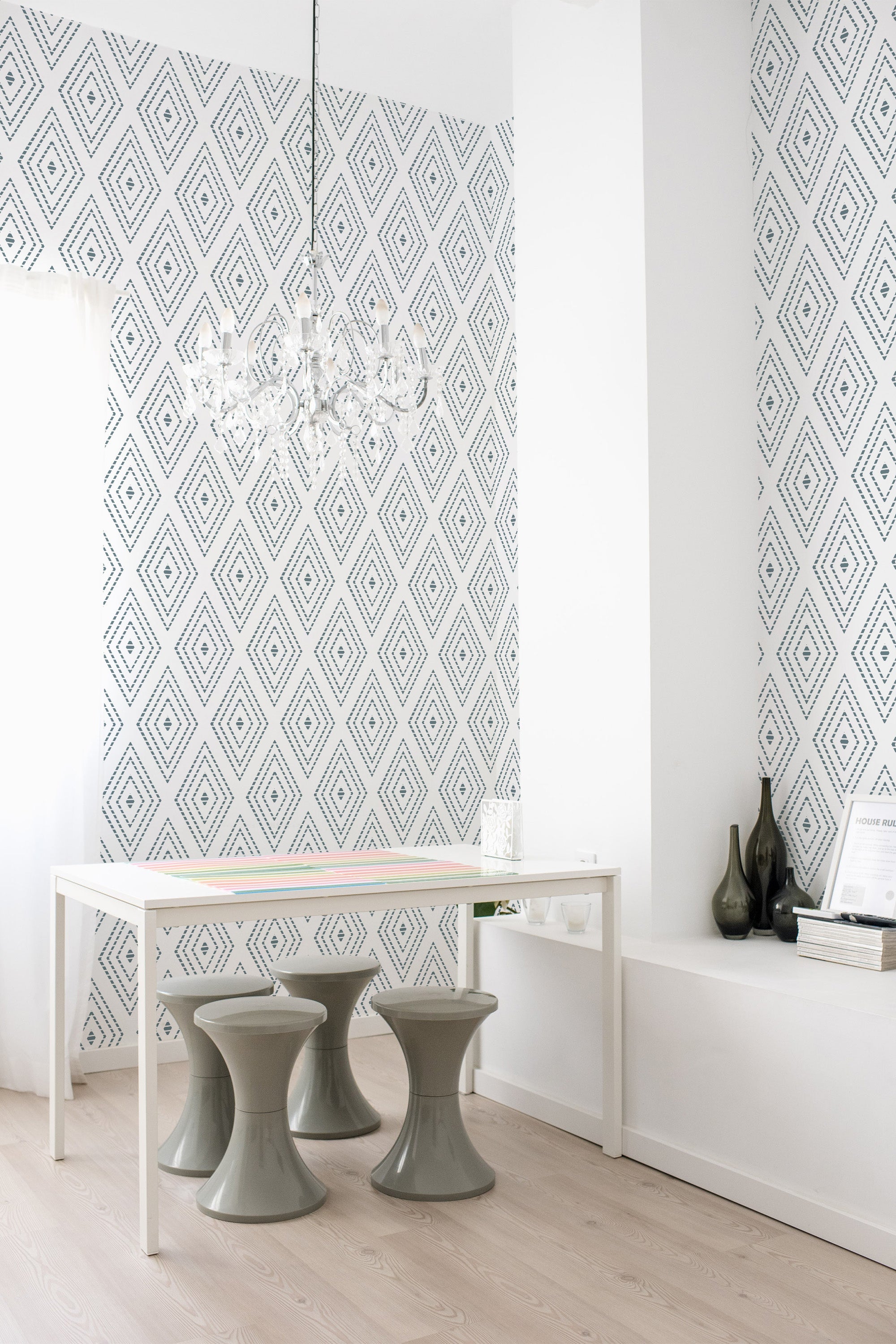 A room with a wallpaper adorned in a pattern of repeating dotted rhombus shapes in neutral tones, adding a subtle geometric touch to the space. Traditional wallpaper.