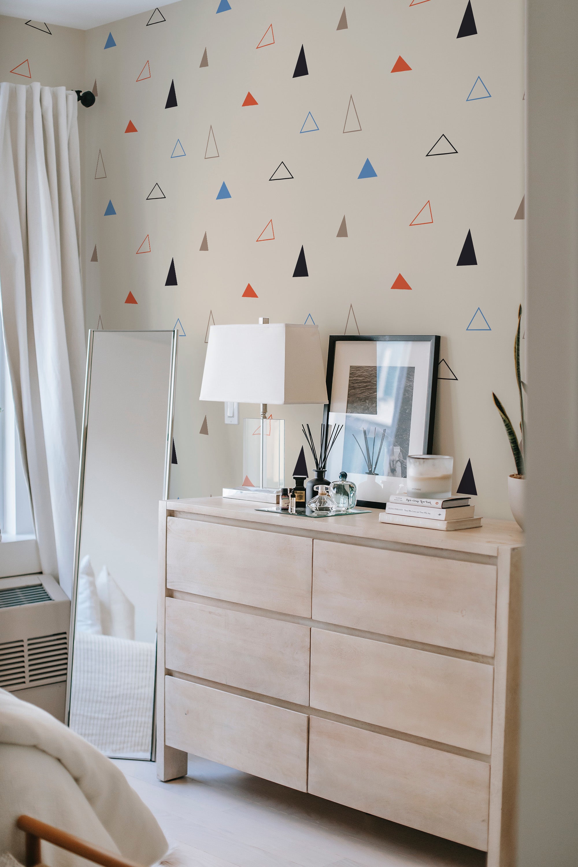 Wallpaper with a Triangle design in various colors, including black, red, blue, and brown, on a light beige background. Traditional wallpaper.