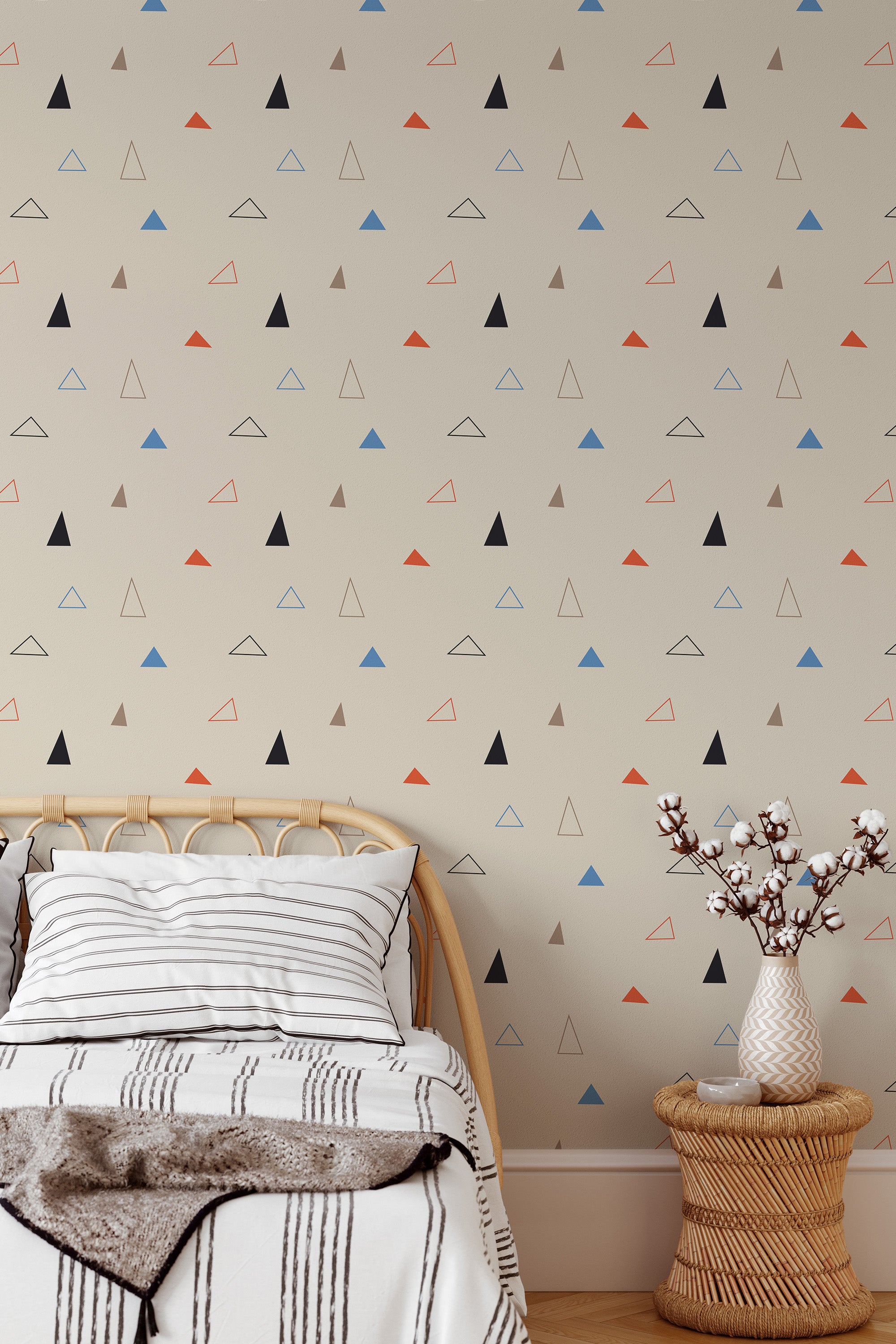 Self-adhesive wallpaper with a Triangle design in shades of black, red, blue, and beige scattered across a light beige background, adding a modern geometric touch to the room.