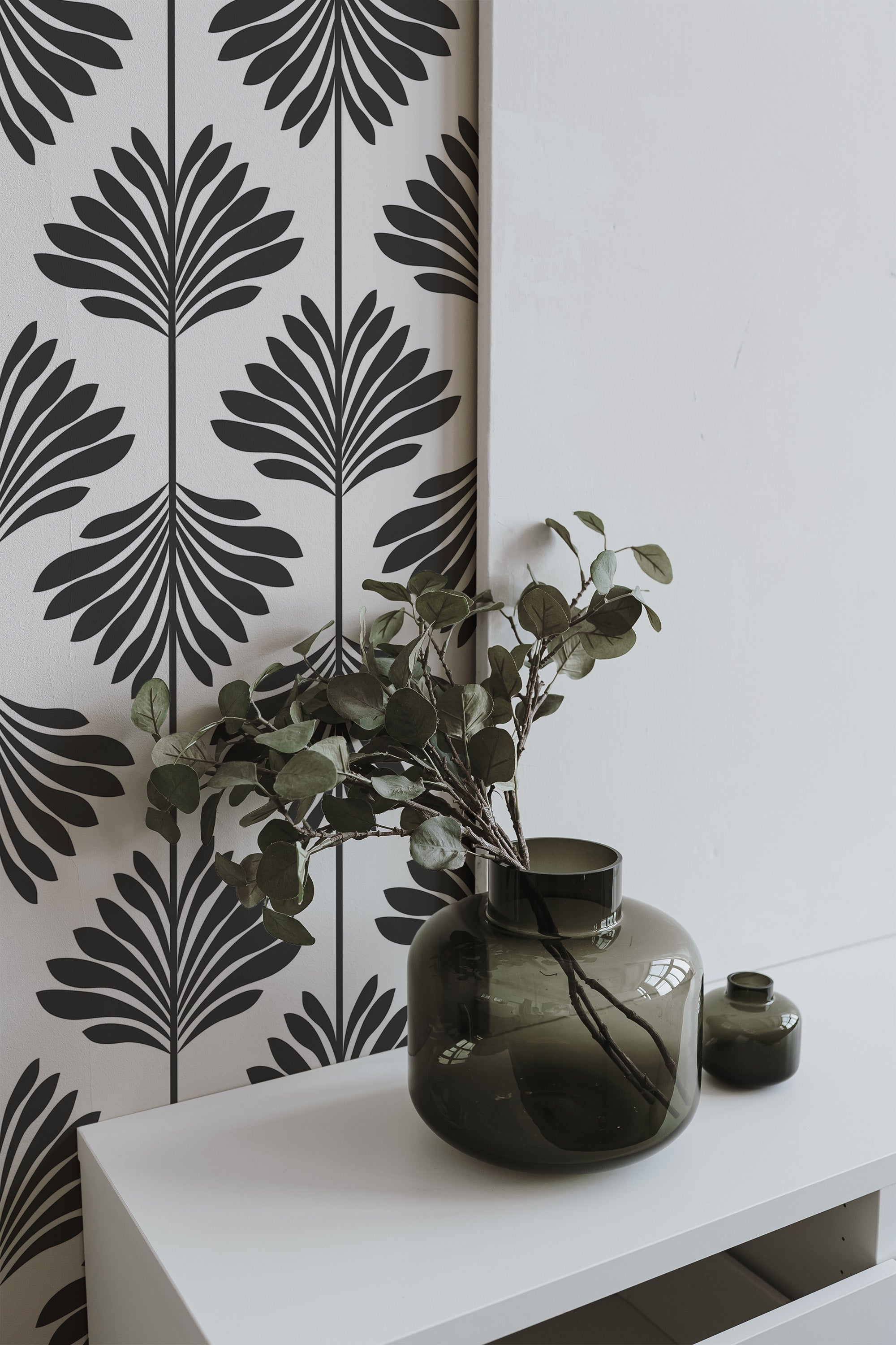 Self-adhesive wallpaper with a bold, black leaf pattern against a white background.