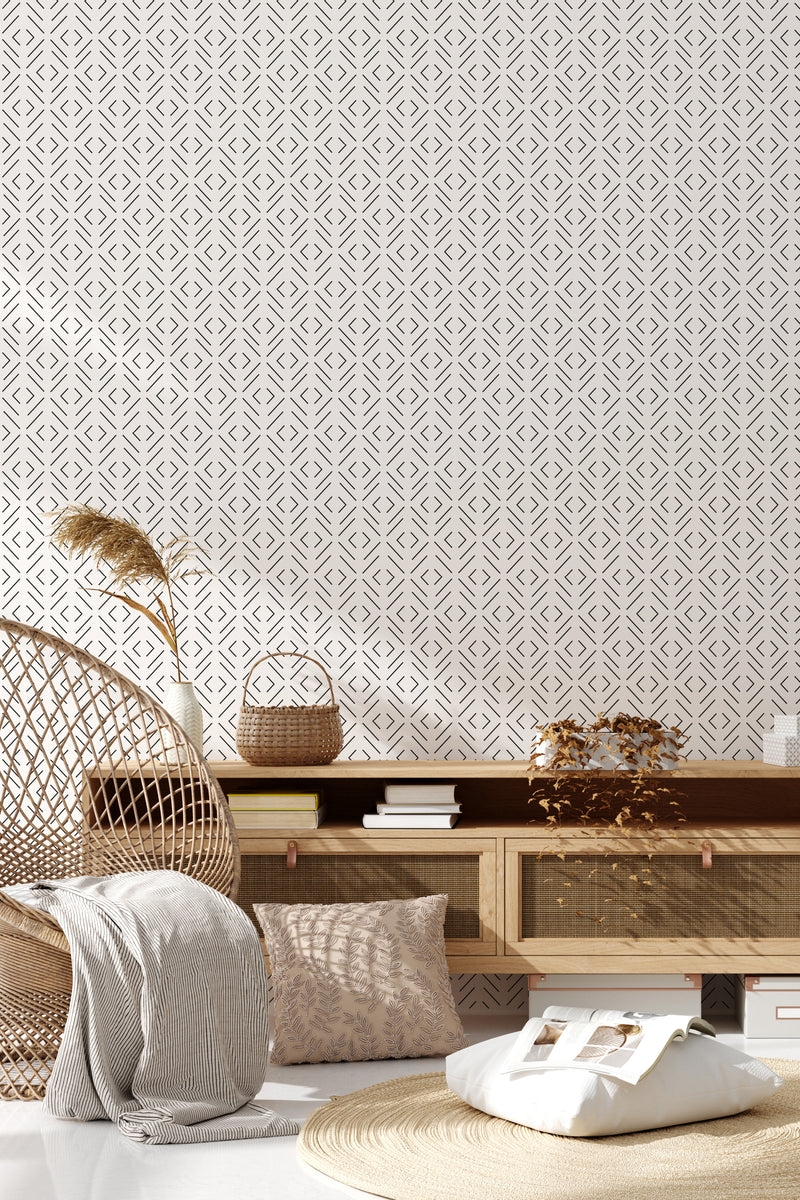 A wall covered with a simple geometric pattern of interlocking diamond shapes in muted tones, creating a subtle and modern yet classic ambiance within the room, representing traditional wallpaper.