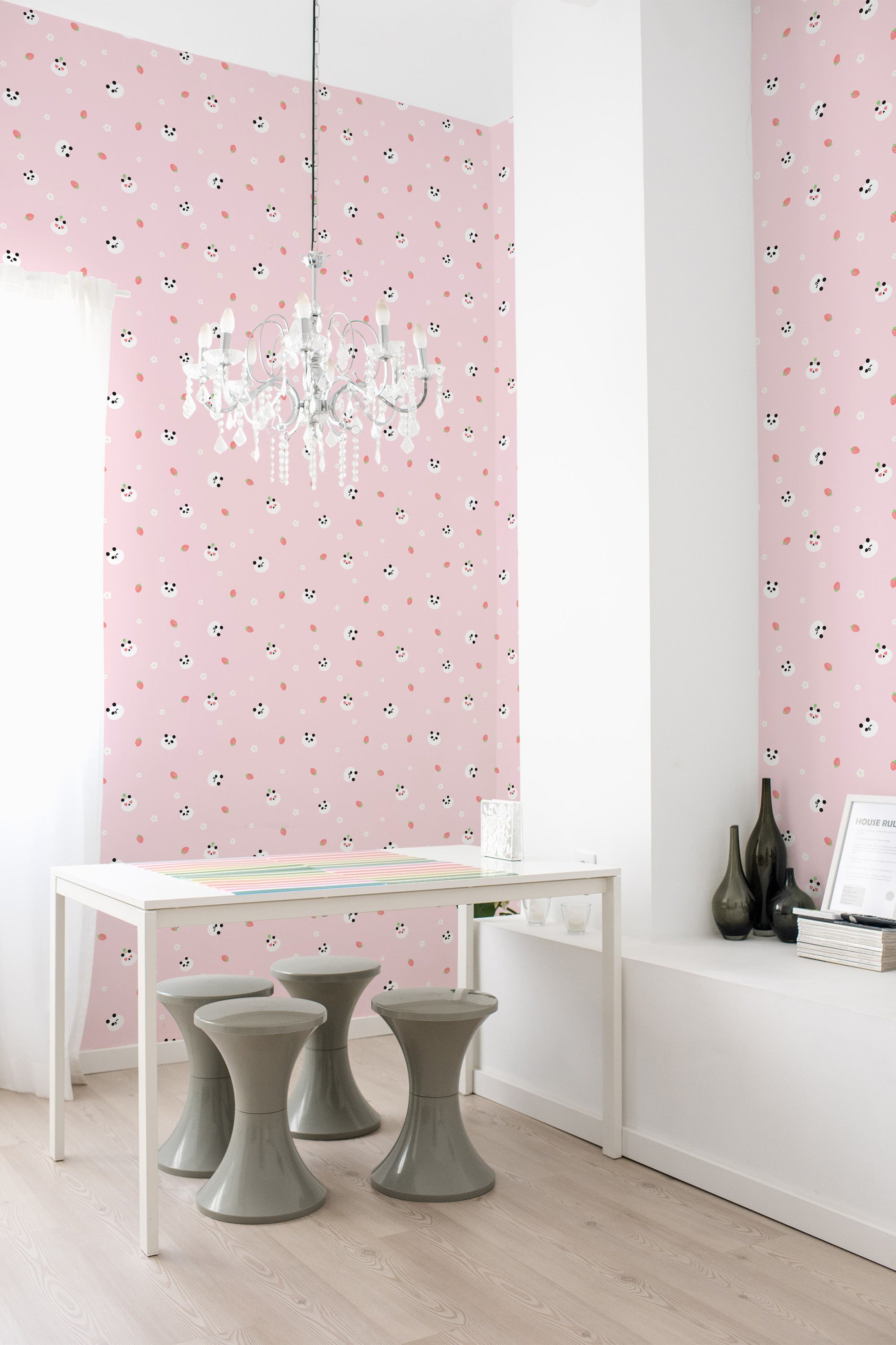Room with pink wallpaper adorned with small, cute cartoon faces and subtle heart shapes, evoking a playful and whimsical aesthetic. Traditional wallpaper.