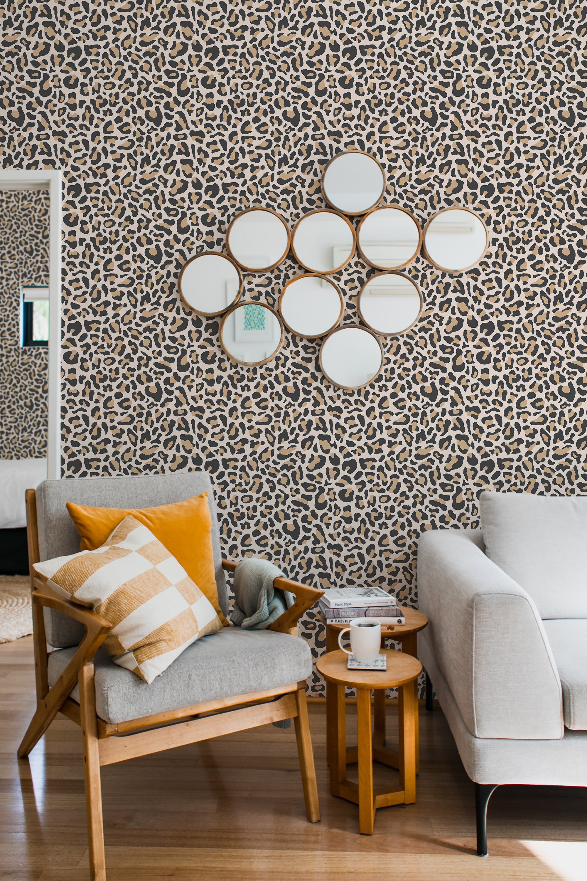 Leopard-print wallpaper with a pattern of irregular, dark spots and smooth, neutral tones on a cream background, adding an exotic and bold touch to the room while maintaining the classic look of traditional wallpaper.