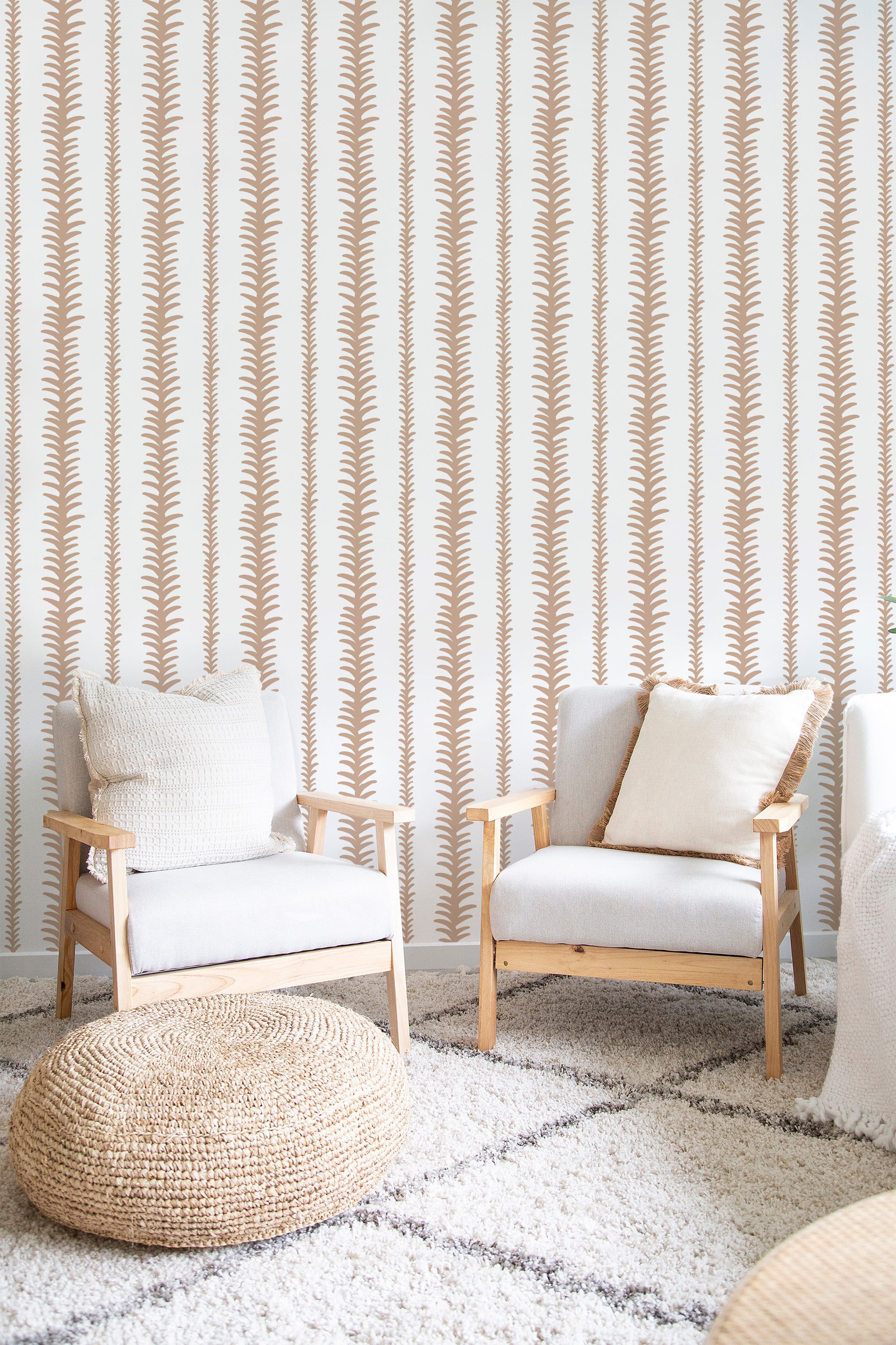 A room with a wall covered in abstract stripe wallpaper, featuring vertical lines of fawn-colored fern-like patterns on a cream background. Matching neutral-toned furniture complements the warm tones of the traditional wallpaper.