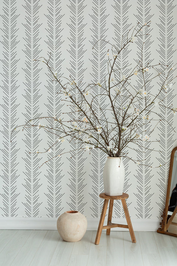 Self-adhesive wallpaper with a Herringbone lines design composed of vertical zigzag patterns in black on a white background.