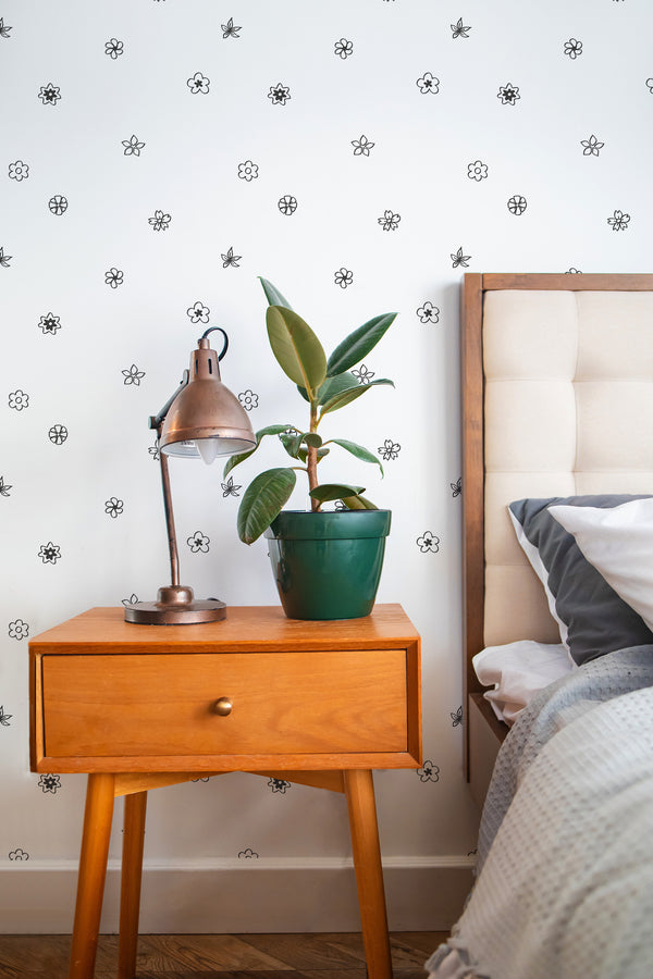 Self-adhesive wallpaper with a Tiny flowers design, small black floral patterns on a white background.