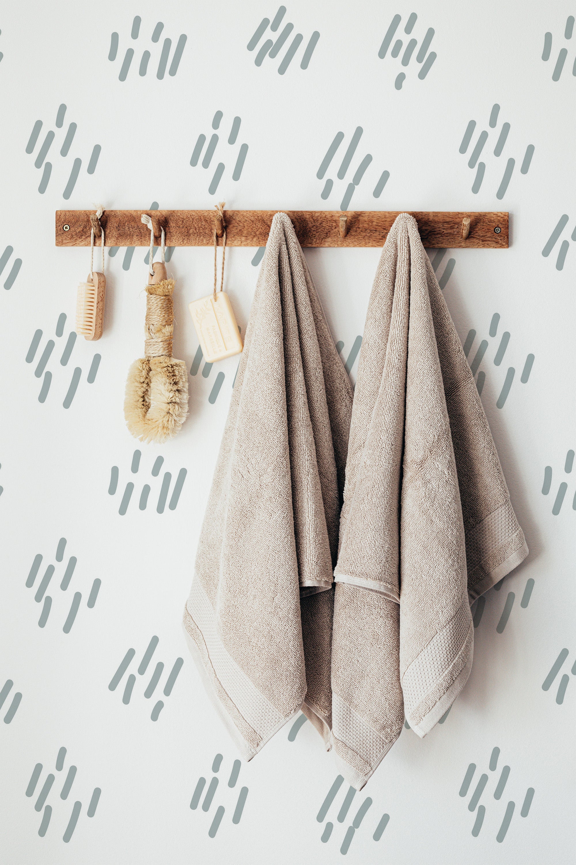 Self-adhesive wallpaper with a minimalist design of soft, gray brushstroke patterns scattered across a white background. The subtle, abstract strokes add a modern and artistic touch to the space.