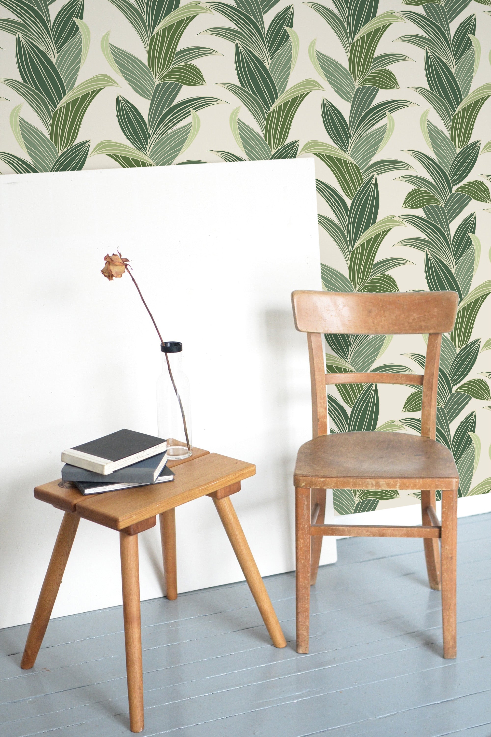 Self-adhesive tropical leaf wallpaper with large, overlapping green leaves against a light beige background, creating a vibrant, lush atmosphere in the room.