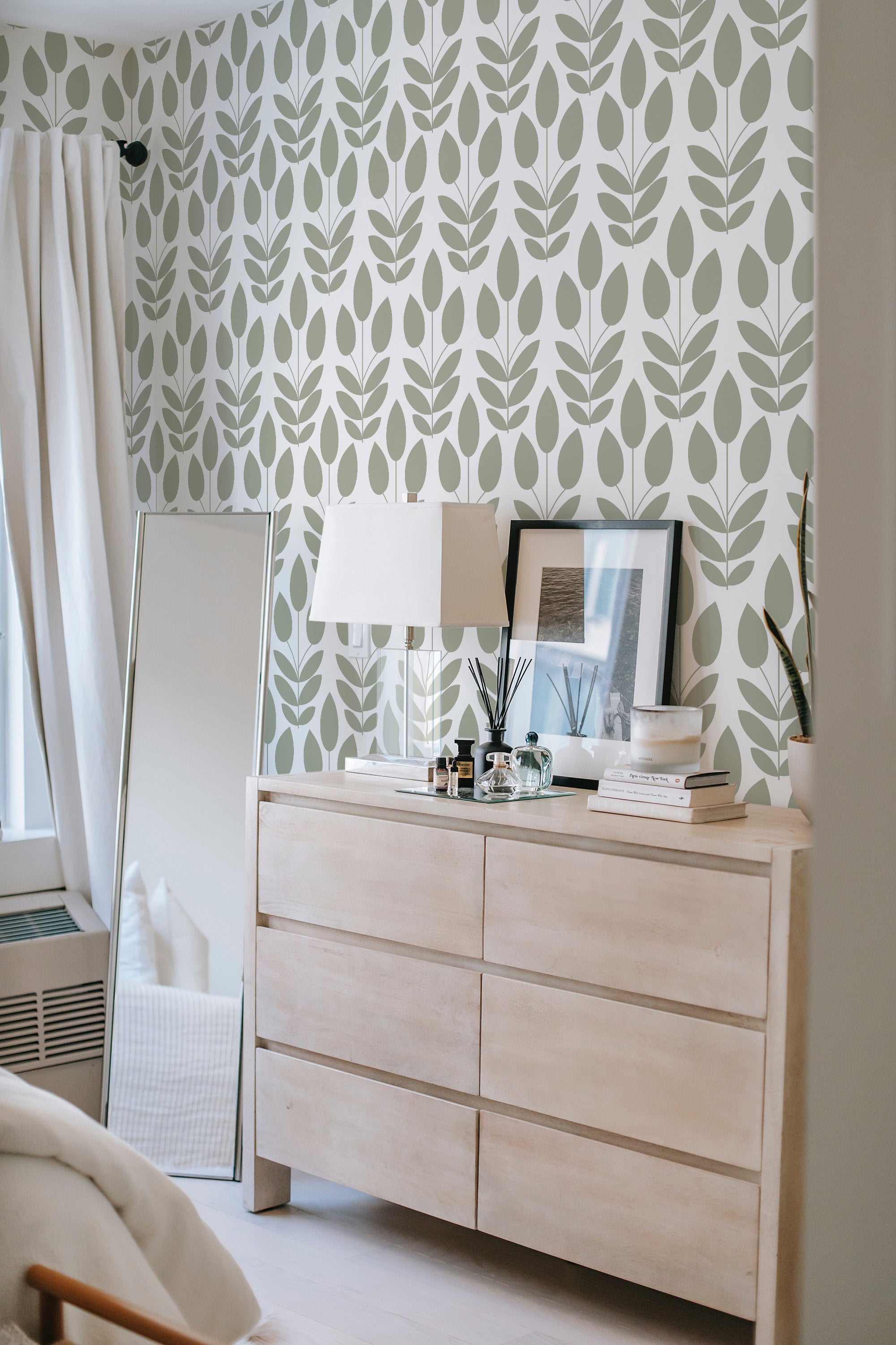 Wallpaper in a Scandinavian design with minimalist green leaf patterns on a white background, adding a natural and calming vibe to the room. Traditional wallpaper.