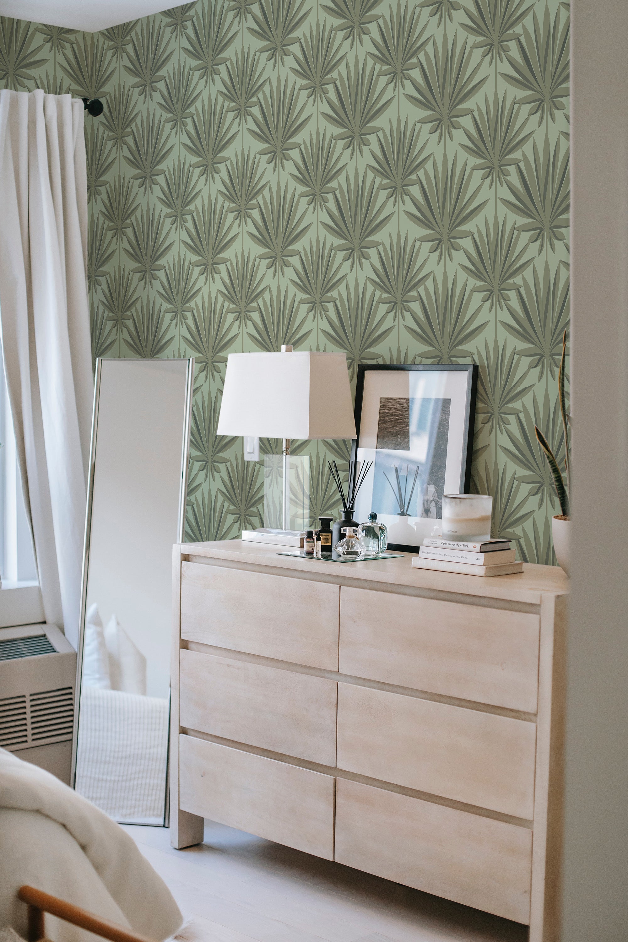 The wallpaper has a pattern of large, stylized palm leaves in muted green tones on a light green background, creating a subtle yet elegant tropical motif. It adds a nature-inspired aesthetic to the room, evoking a blend of sophistication and tranquility. Traditional wallpaper.
