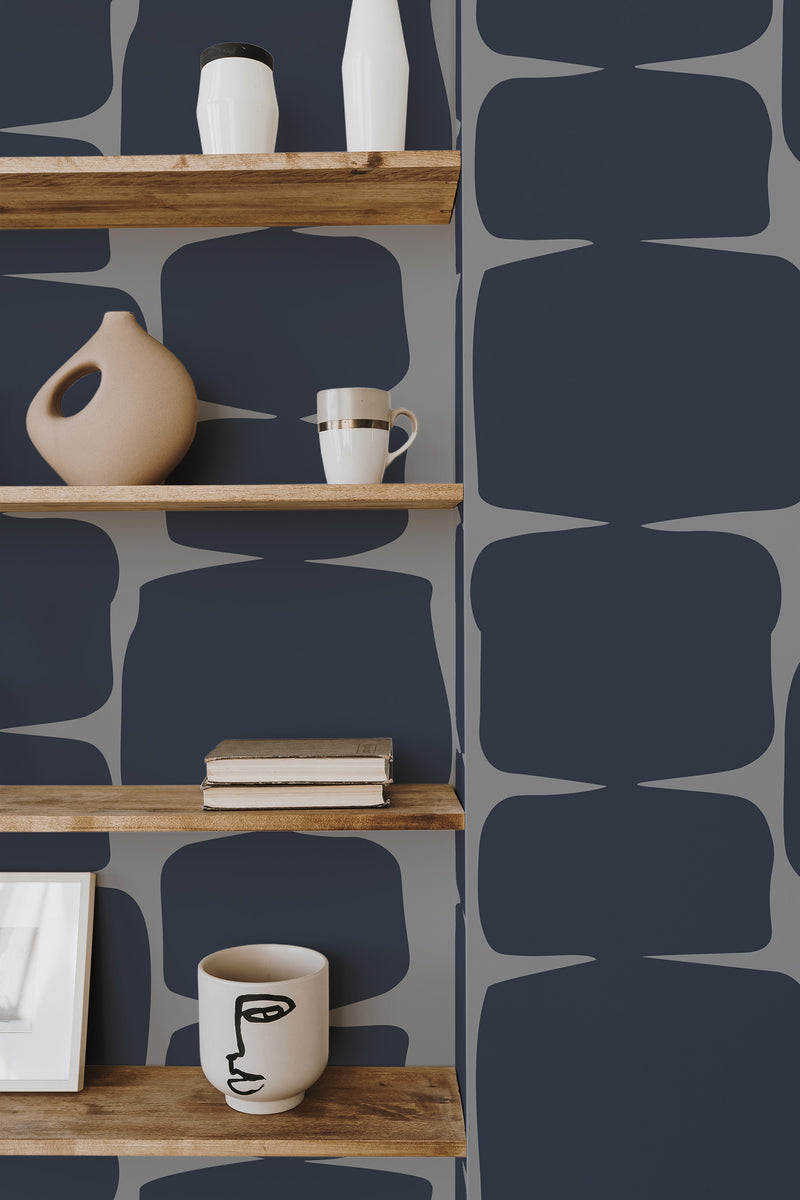 Self-adhesive wallpaper with a Navy retro shape design creates a bold geometric pattern using organic, curved rectangles in a deep navy color against a muted gray background.