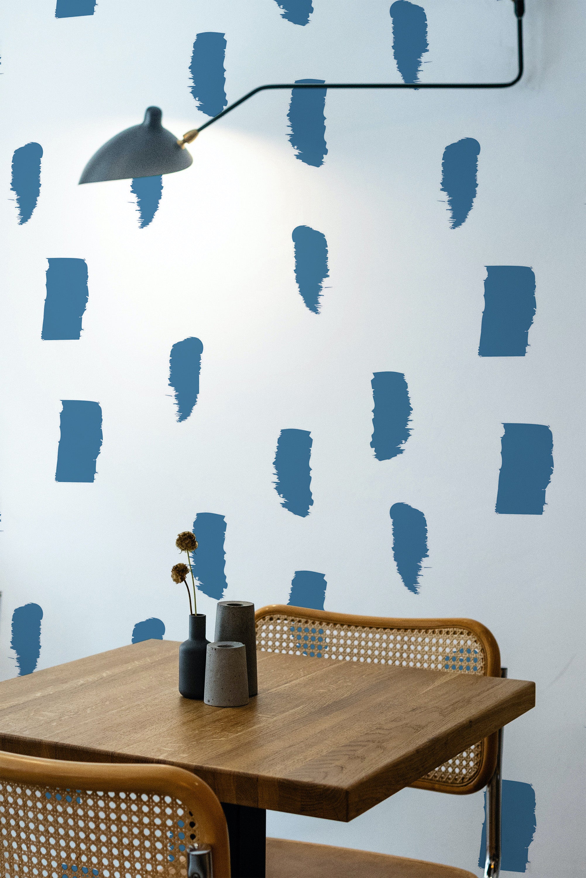 Self-adhesive wallpaper with a Painted stroke design in blue brush-like marks scattered across a white background, creating a modern and artistic look in the room.