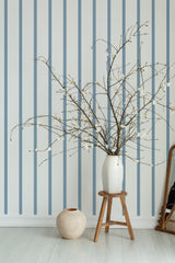 Self-adhesive wallpaper with elegant French stripes in muted blue and cream tones, creating a classic and refined atmosphere.