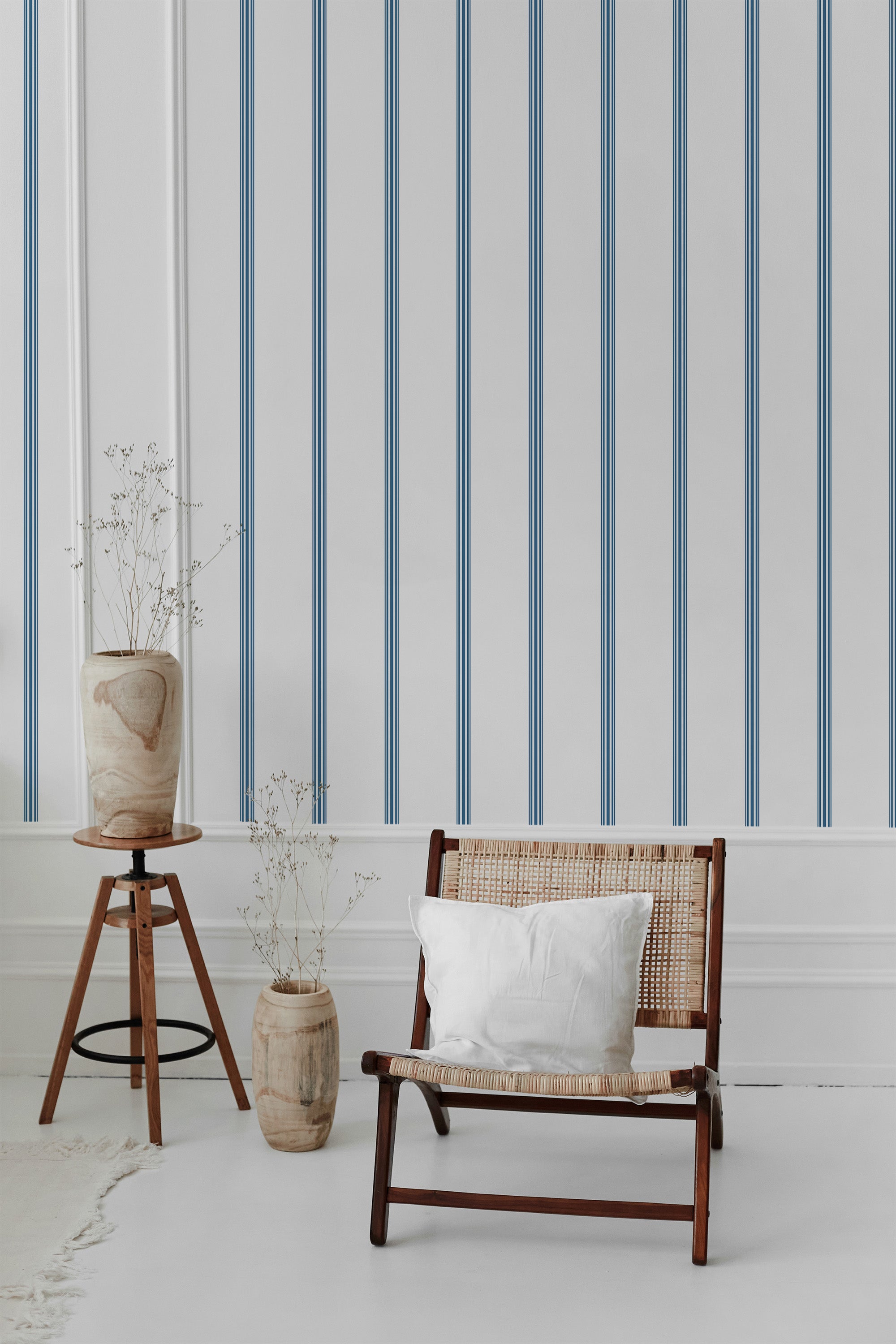 Vertical blue and white stripes arranged on a clean background, creating a classic, refined look with subtle texture. Traditional wallpaper.