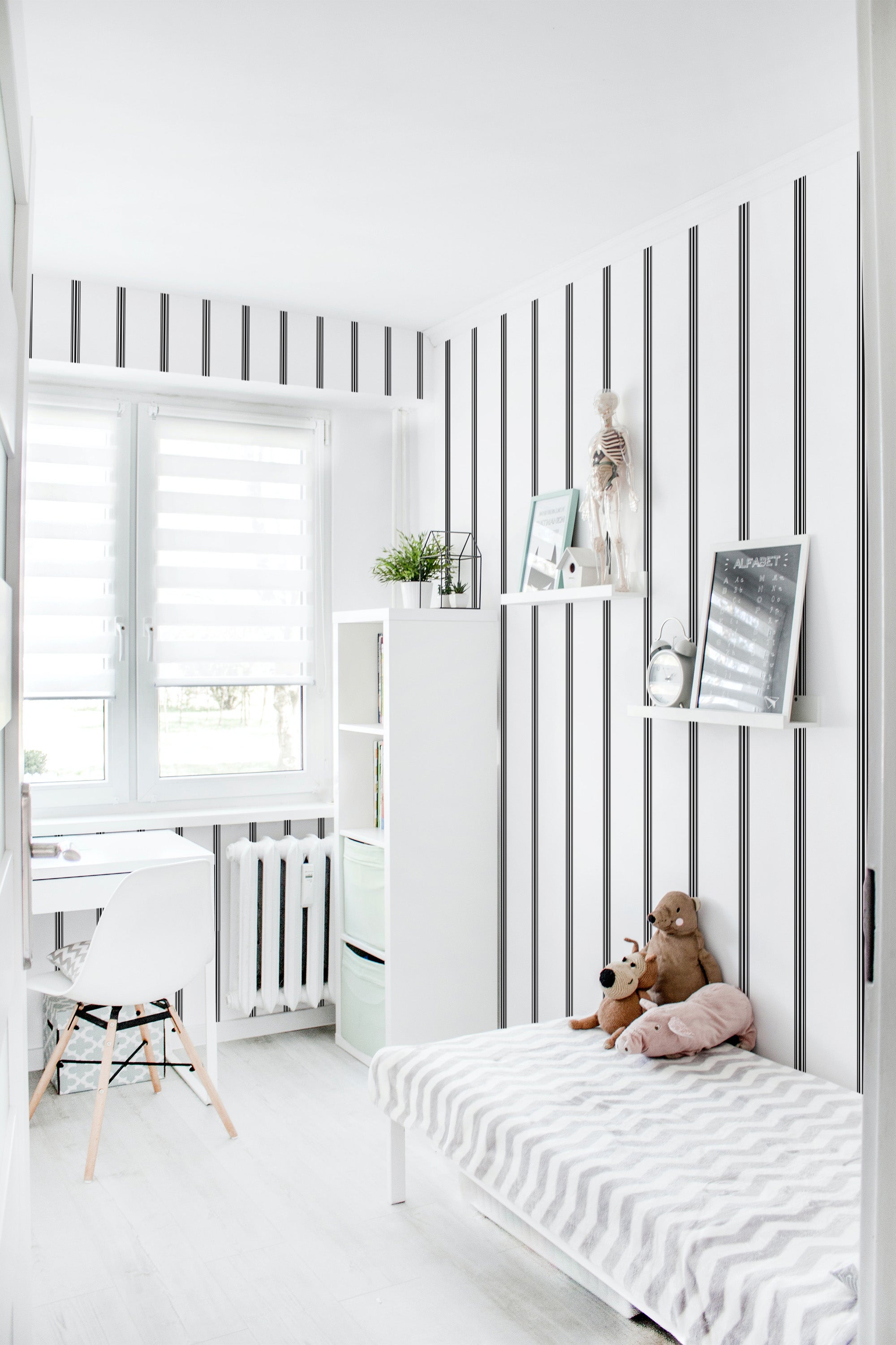 Room with white and black vertical striped design on the wallpaper, creating a clean and classic look. The room has minimalistic decor with a bed, shelves, and a small desk by the window. Traditional wallpaper.
