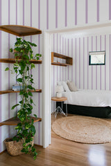bedroom cozy interior green plants round carpet purple striped peel & stick wallpaper