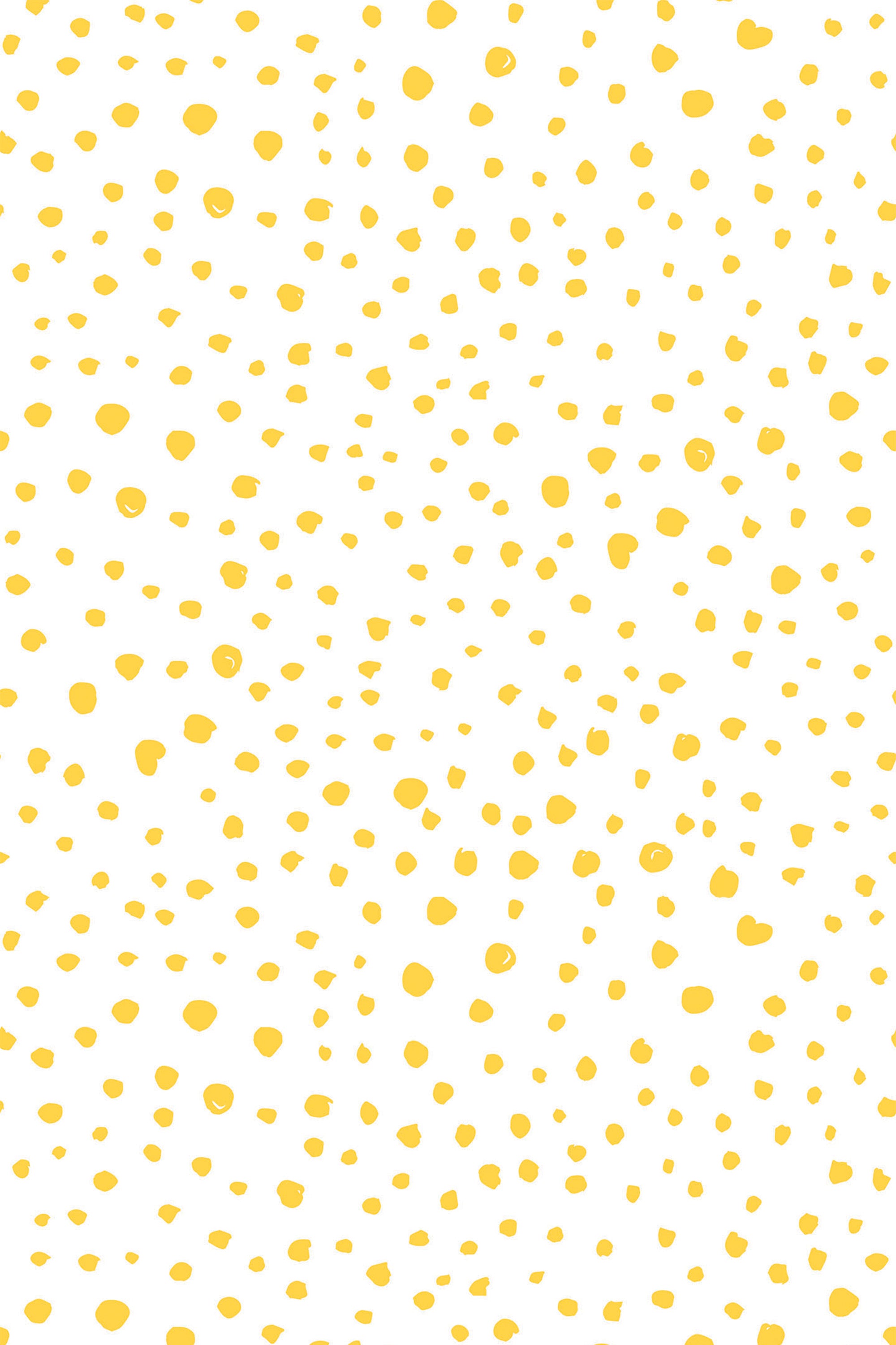 Yellow speckled dots scattered randomly on a white background. Peel and stick removable wallpaper.