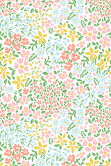 Colorful floral pattern with pink, yellow, and blue flowers surrounded by green leaves on a white background. Peel and stick removable wallpaper.