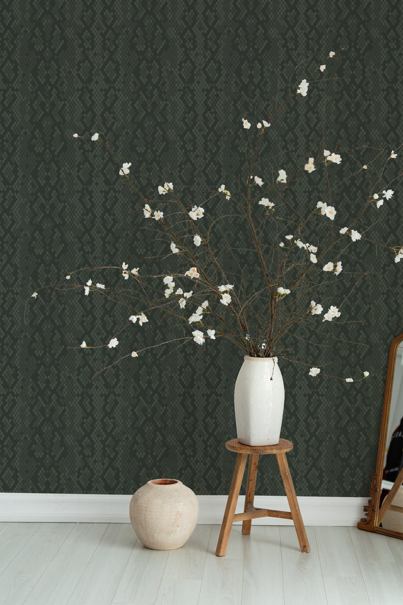 Self-adhesive wallpaper with a sophisticated snake skin pattern in dark green tones, adding a textured and exotic touch to the room.