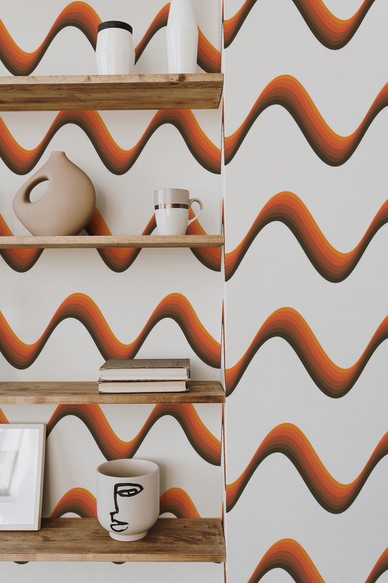 Self-adhesive wallpaper with wavy lines in earthy tones of orange, brown, and black on a white background, adding a Boho-inspired aesthetic to the room.