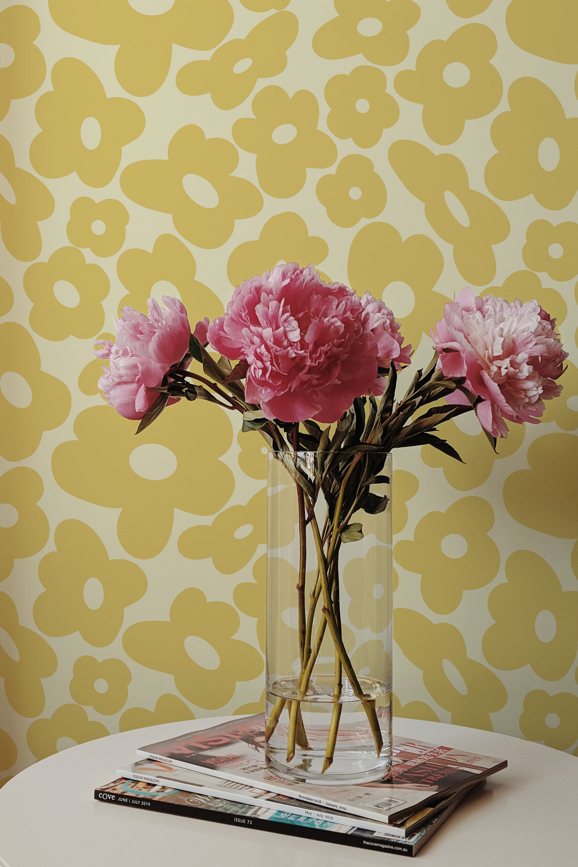 Self-adhesive wallpaper with a yellow funky flower pattern of large, abstract floral shapes, creating a playful and vibrant backdrop.