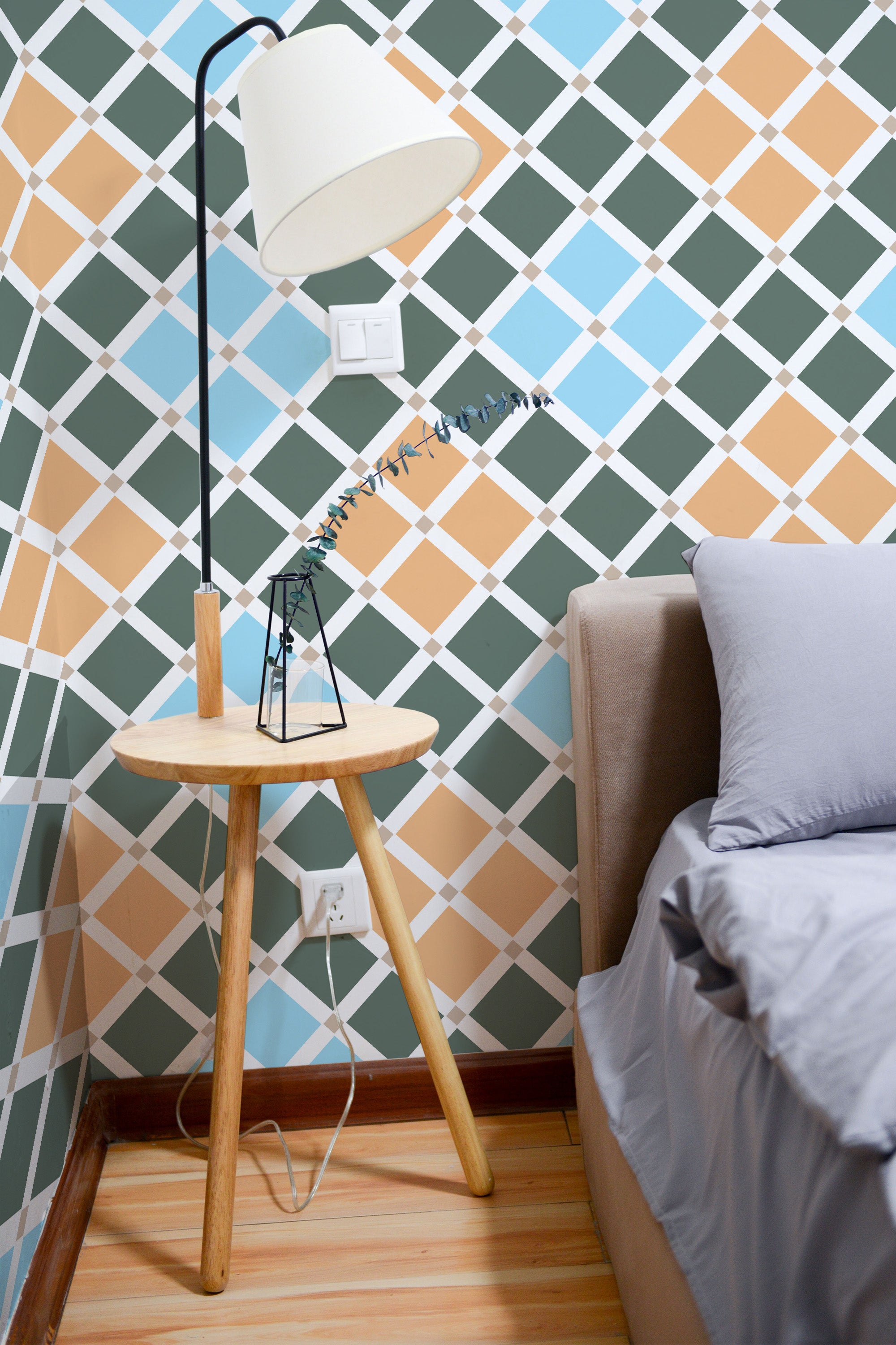 Self-adhesive tile mosaic wallpaper with a geometric pattern. The design includes intersecting diamond shapes in colors like green, blue, peach, and white, creating a checked grid effect across the wall.