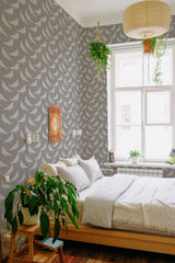 A cozy room with wallpaper adorned in a repeated pattern of white pigeons against a soft gray background, giving the space a peaceful and classic ambiance. Traditional wallpaper.