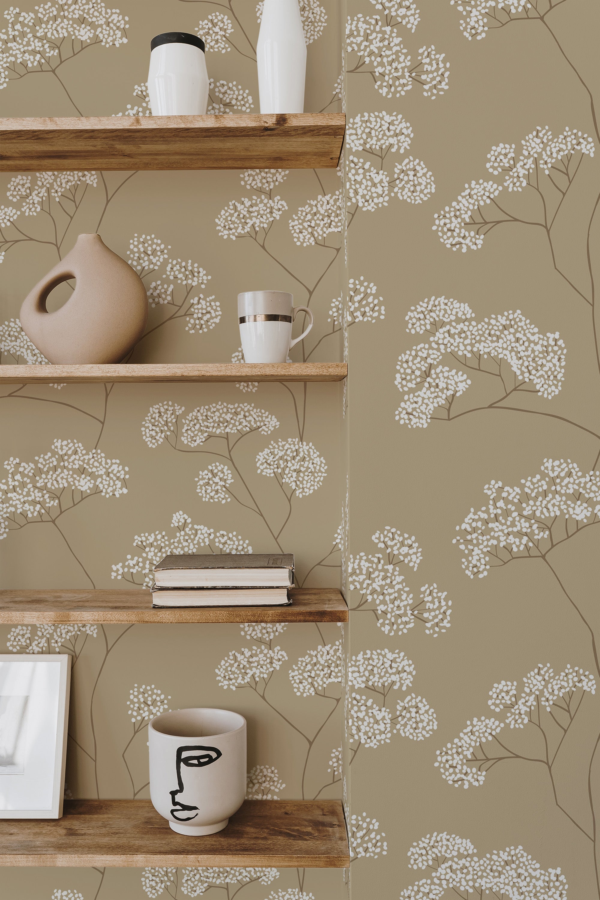 Self-adhesive wallpaper with a neutral floral pattern on a soft olive-green background, adorned with delicate white blossoms and brown stems.