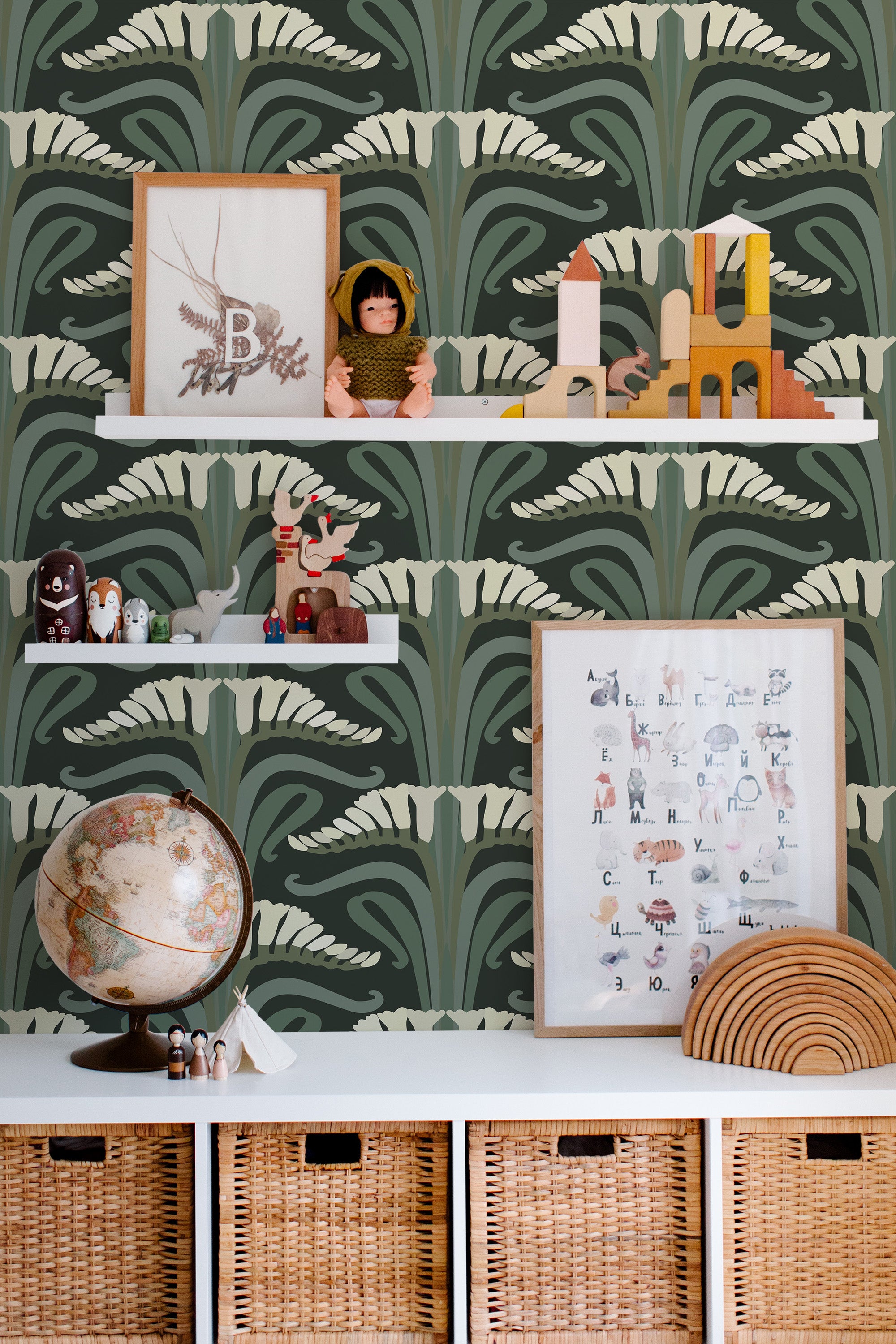Self-adhesive Art Nouveau wallpaper with a symmetrical, stylized floral pattern in shades of green and cream, behind white floating shelves adorned with decorative items.
