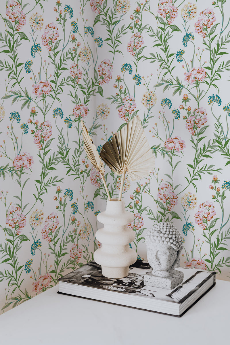 Self-adhesive wallpaper in a pastel meadow design with delicate flowers in soft pink, blue, and green hues, creating a serene and natural atmosphere on the wall.