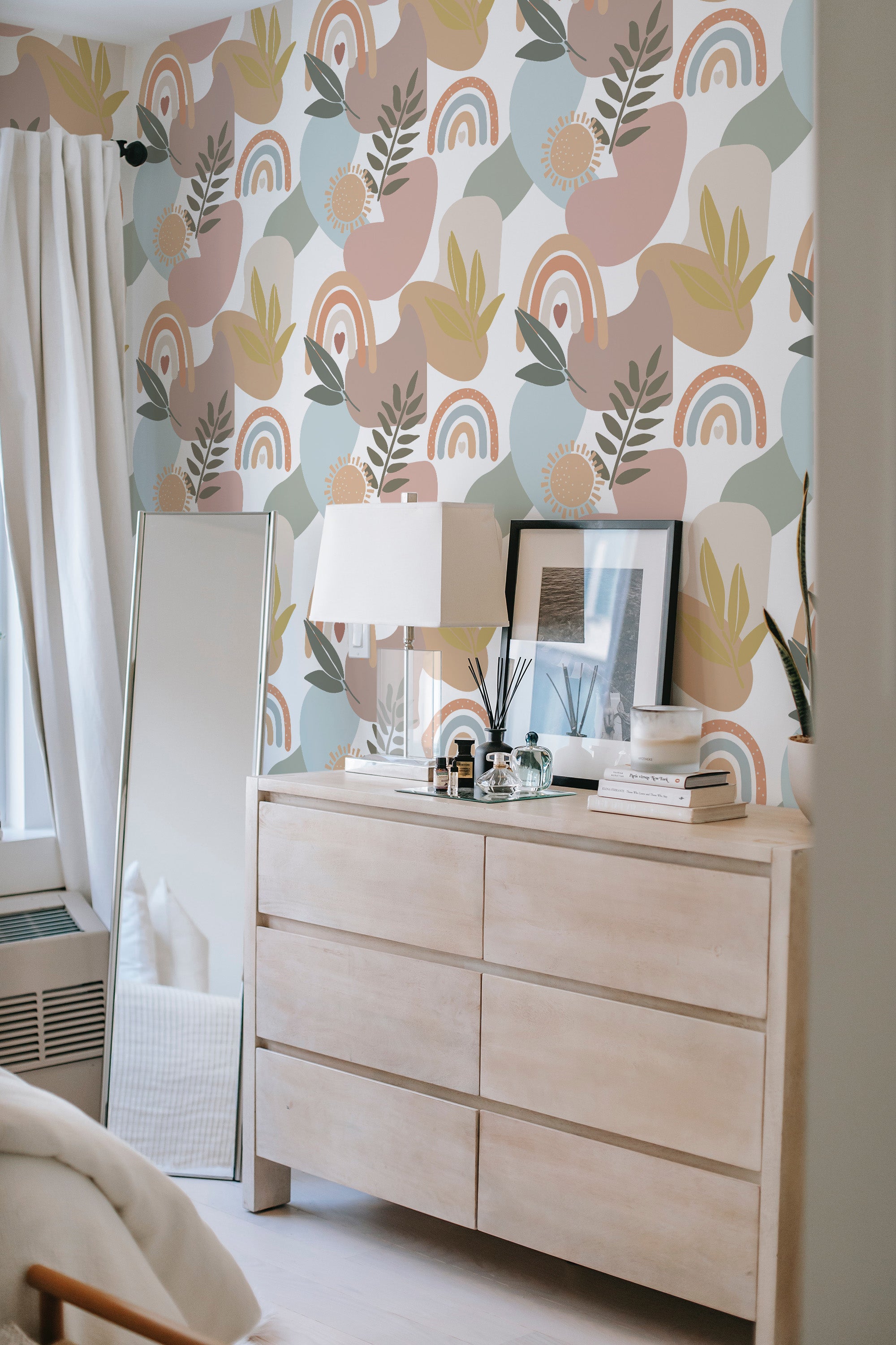 The wallpaper design incorporates abstract, earthy shapes in muted tones including soft pinks, greens, and blues, with patterns resembling rainbows, leaves, and floral elements on a light background. The overall look is modern with a bohemian, nature-inspired aesthetic, paired with traditional wallpaper.